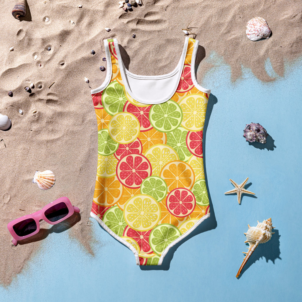 A girls tropical citrus fruit buttery soft yellow one-piece swimsuit with playful citrus pattern and upf 50+ protection