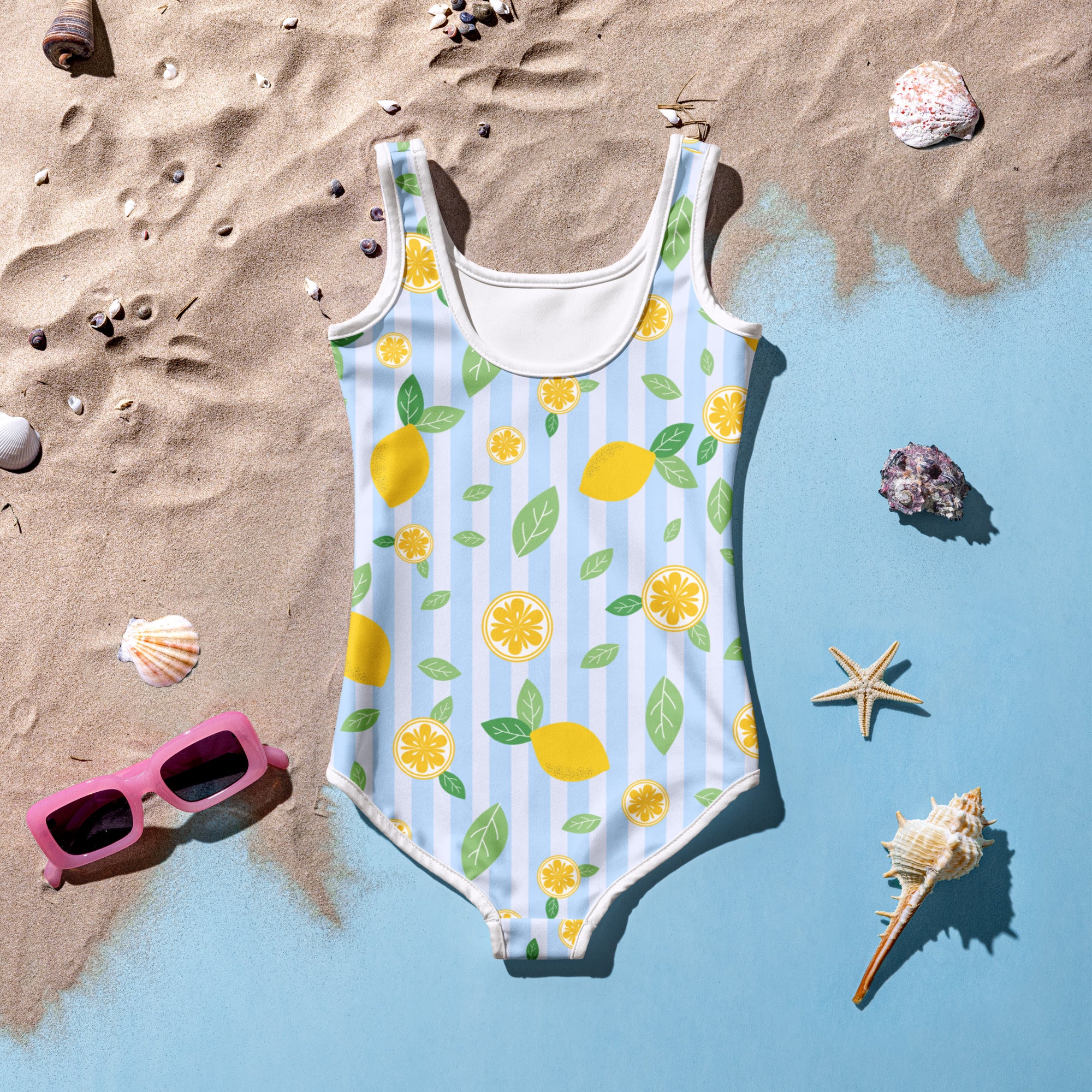 A girls light blue one-piece swimsuit with white trim and lemon slice pattern with upf 50 plus buttery soft fabric