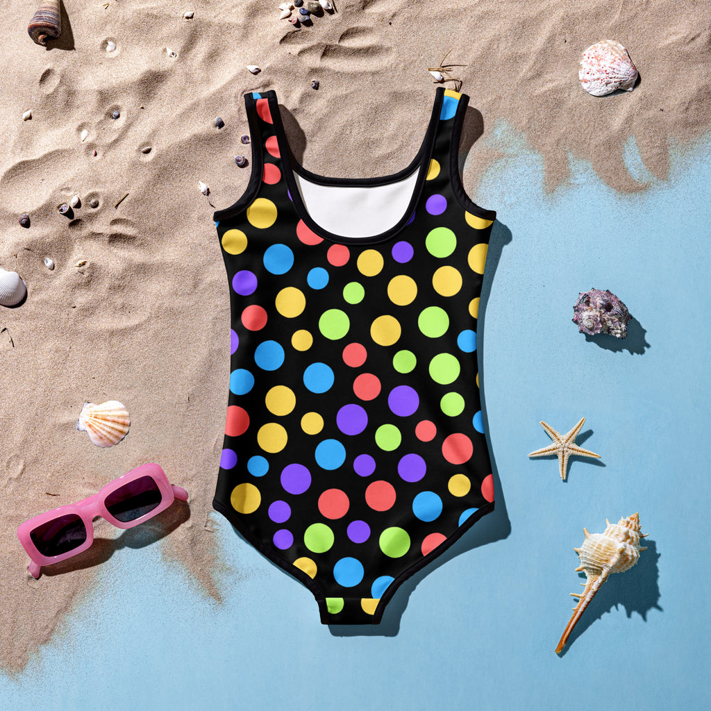 A vibrant black girls one-piece swimsuit with multicolored polka dots made of buttery soft fabric with UPF 50+ protection