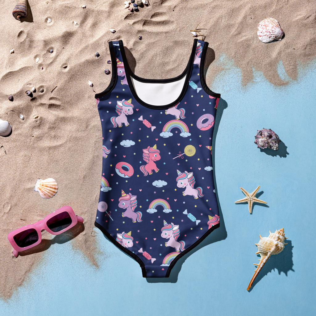 Navy blue girls buttery soft one-piece swimsuit with playful pink and purple unicorns rainbows and candy print with black trim and UPF 50+