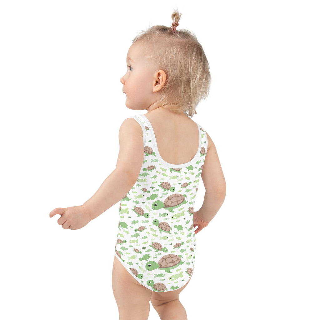 White one-piece girls swimsuit with green and brown sea turtle pattern buttery soft fabric and UPF 50+ protection