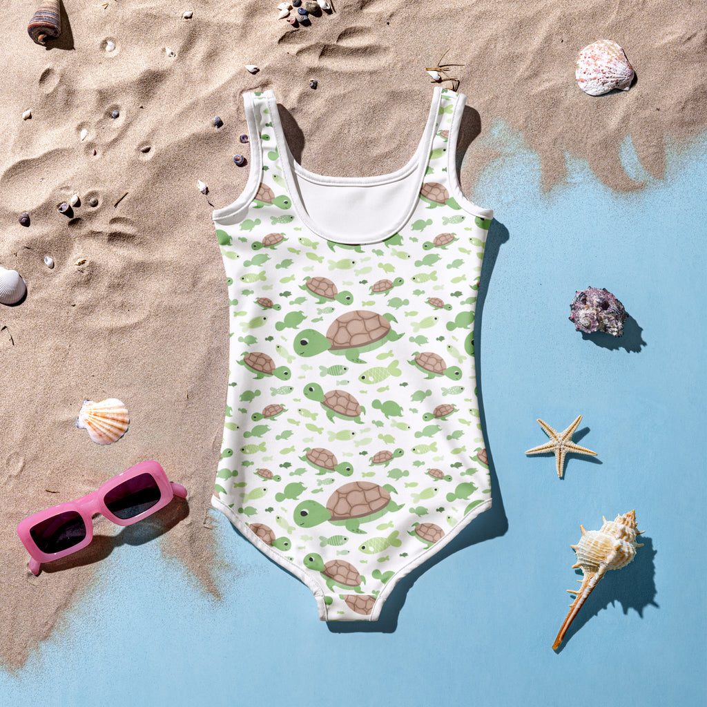 A white girls one-piece swimsuit with green and brown sea turtles and buttery soft fabric with UPF 50 plus protection