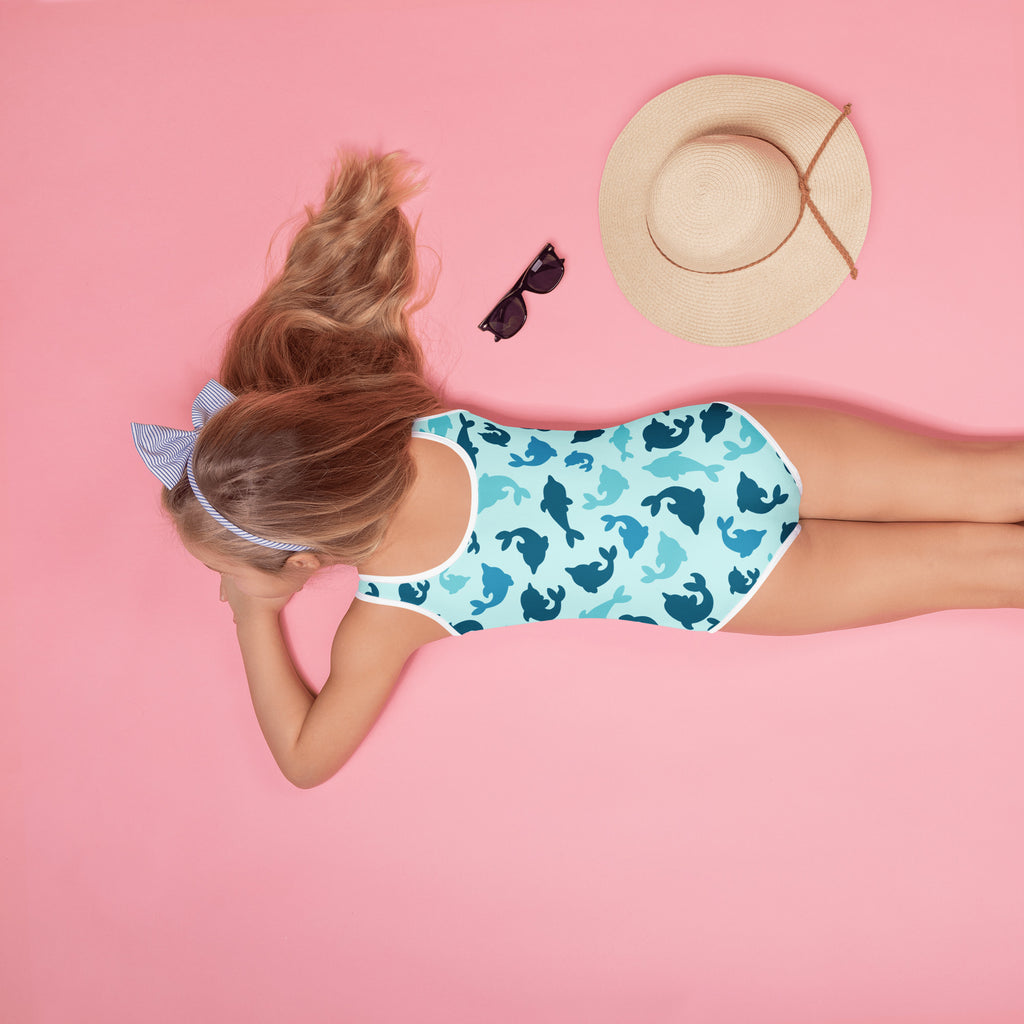 Girls blue dolphin buttery soft one-piece swimsuit with upf 50 plus featuring a playful dark blue and teal dolphin pattern