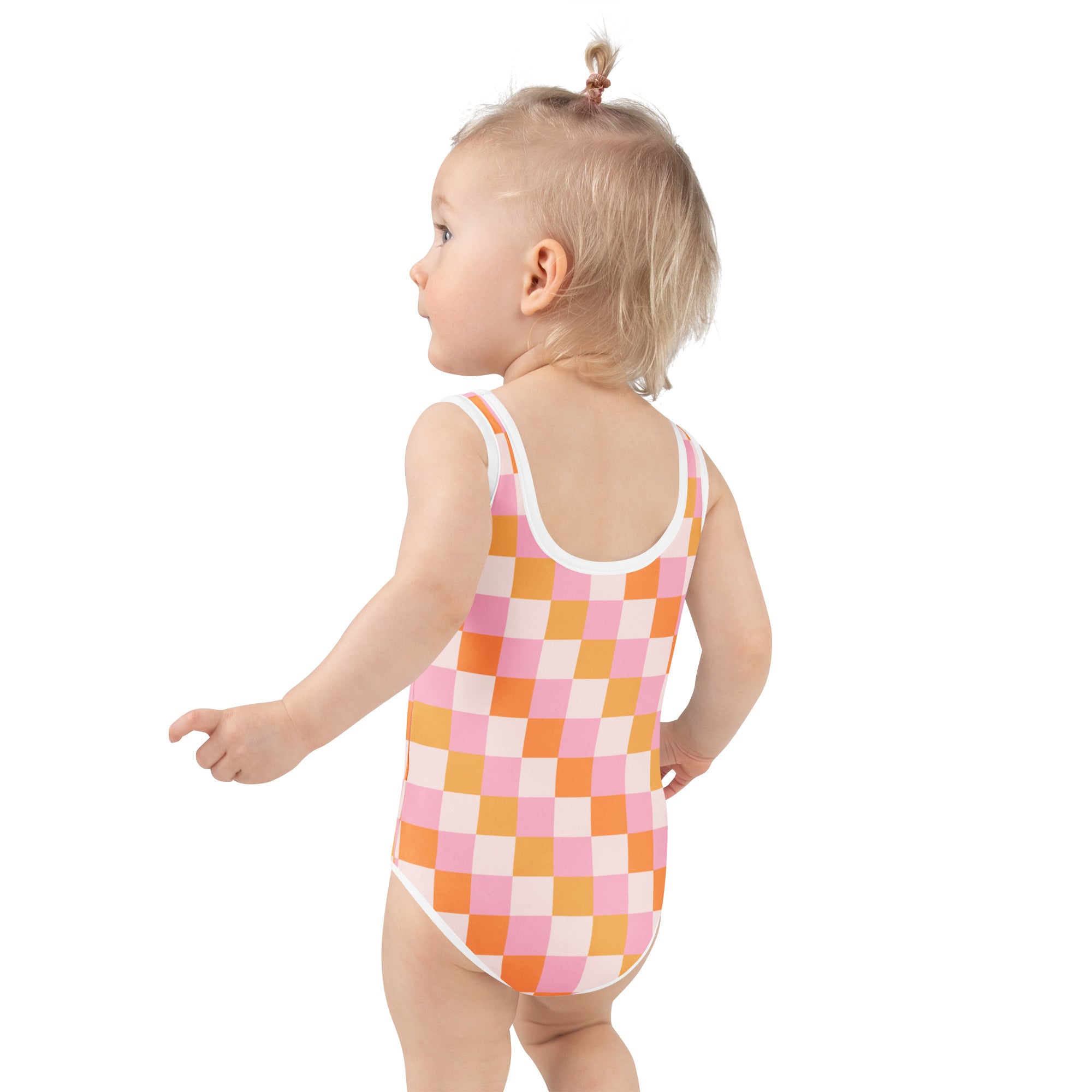A toddler wearing a girls pink and orange checkered buttery soft swimsuit with UPF 50+ and white trim