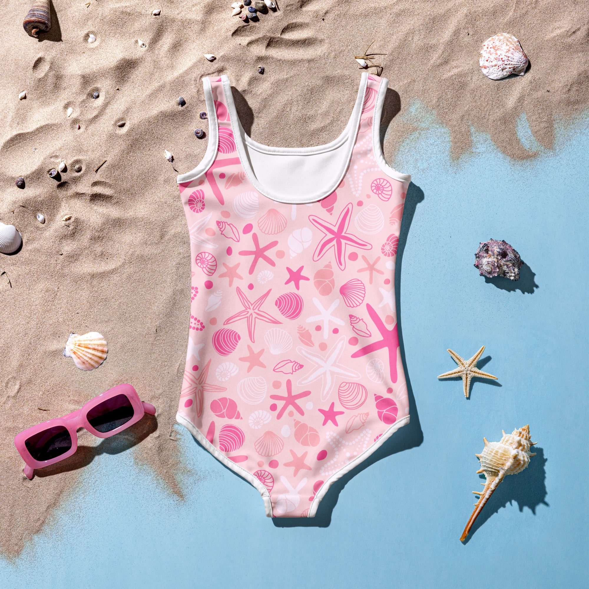 Girls pink starfish and seashell buttery soft swimsuit with white trim and upf 50 plus for sun protection