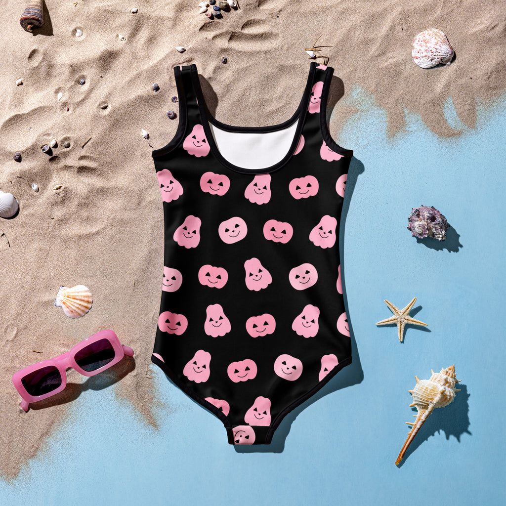 Black buttery soft one-piece swimsuit for girls with pink smiling pumpkin and ghost halloween patterns and UPF 50+ protection