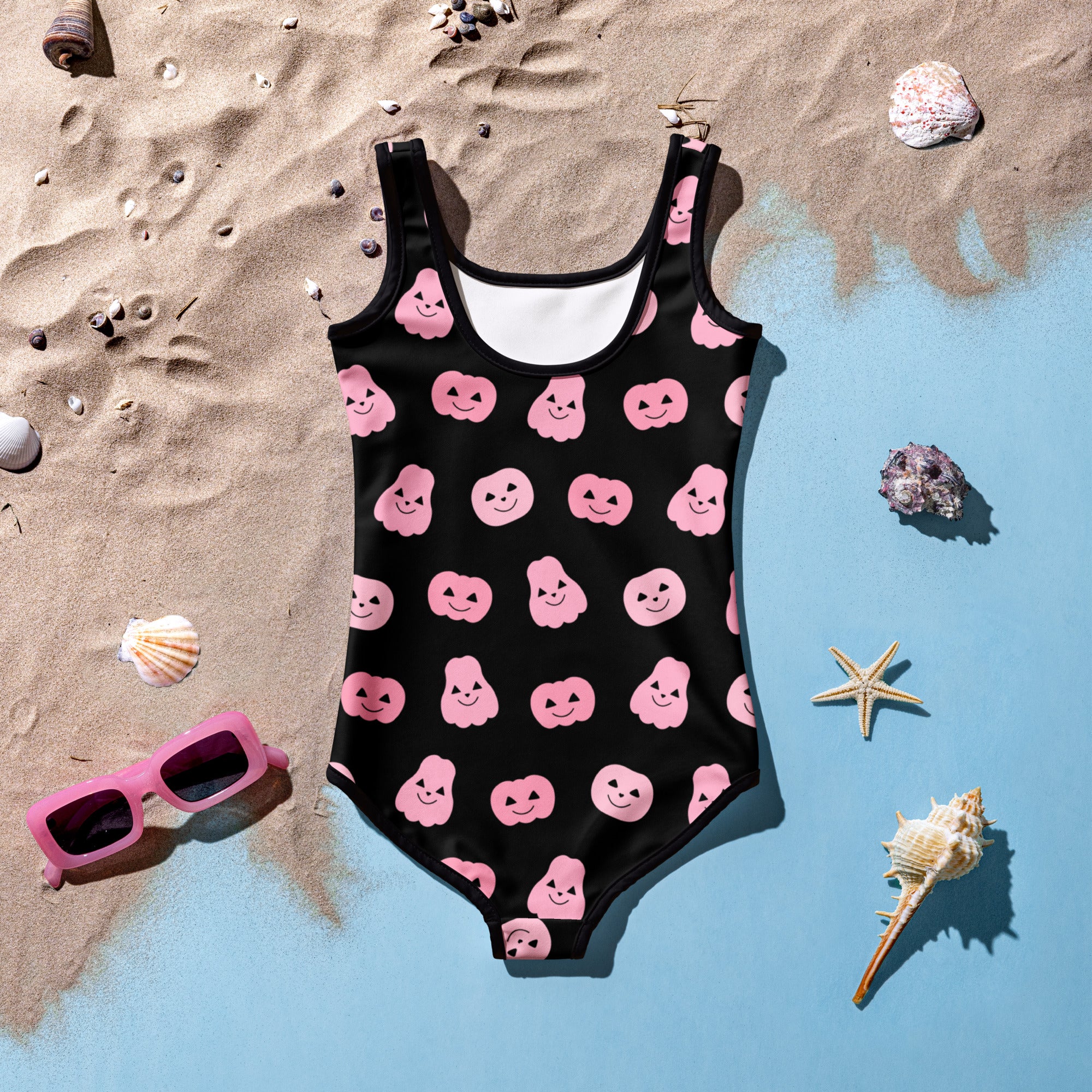 Black buttery soft one-piece swimsuit for girls with pink smiling pumpkin and ghost halloween patterns and UPF 50+ protection