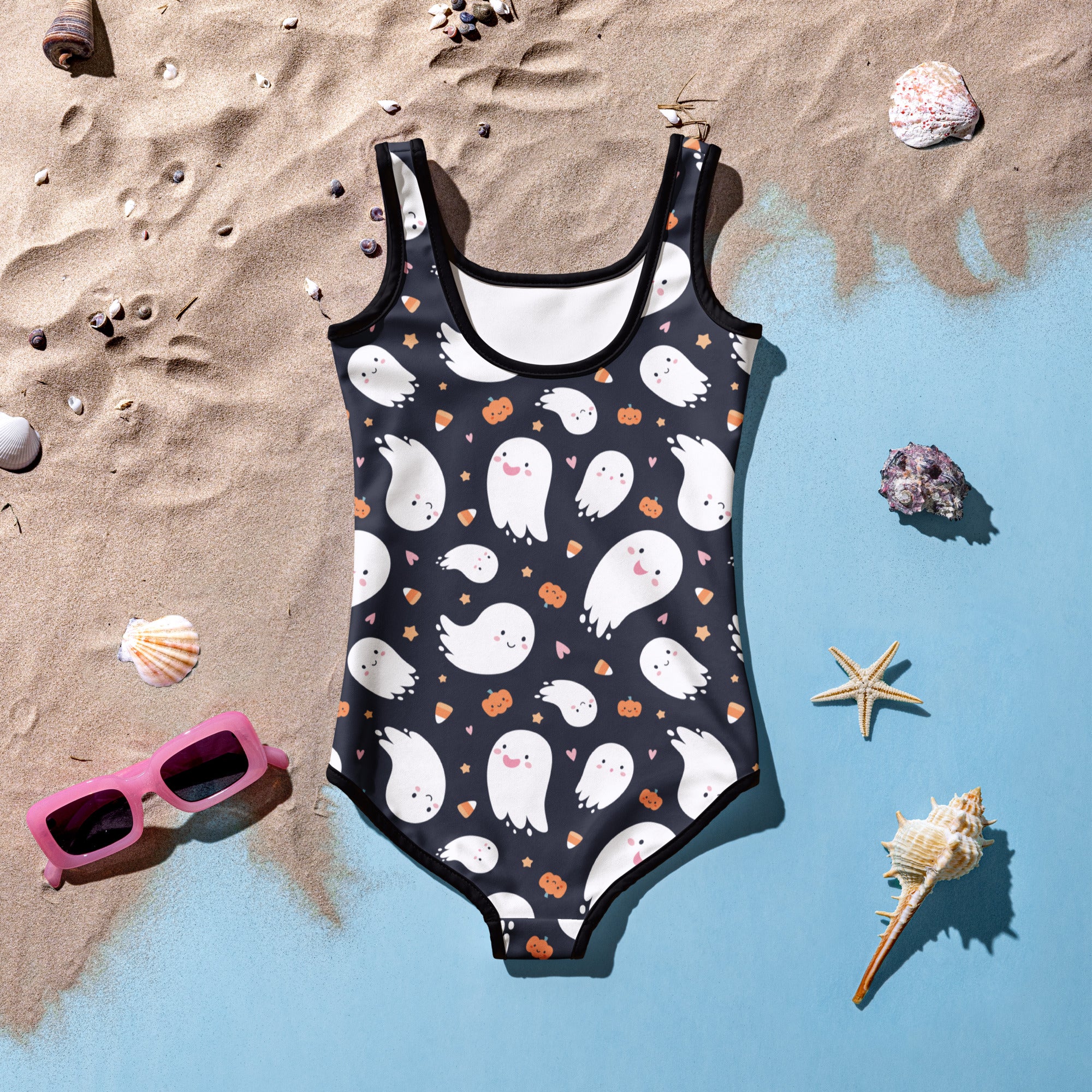 Black one-piece girls swimsuit with white cartoon ghosts orange pumpkins and tiny hearts for halloween use