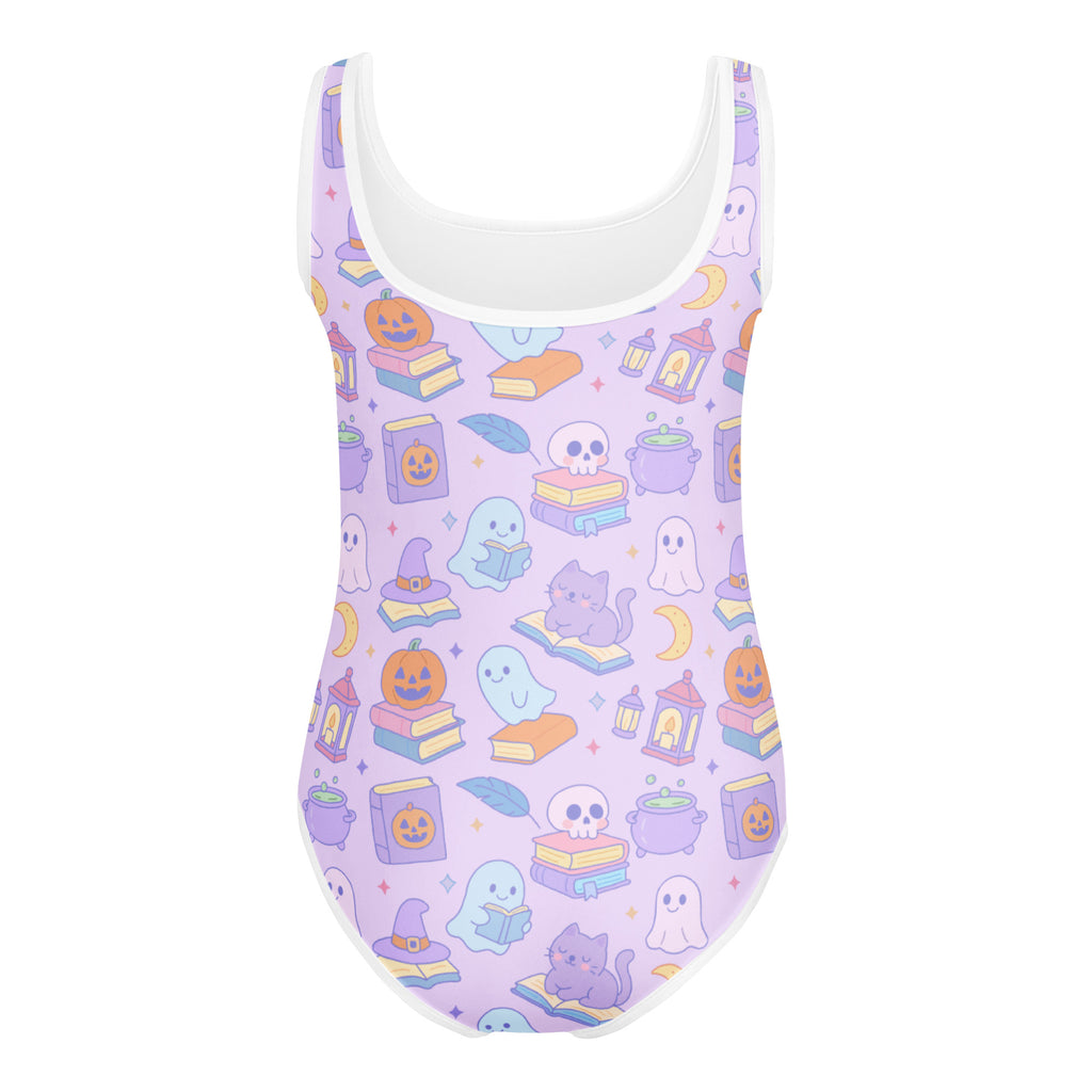 Lavender girls book themed Halloween buttery soft one-piece swimsuit with white trim and playful pastel patterns for dance