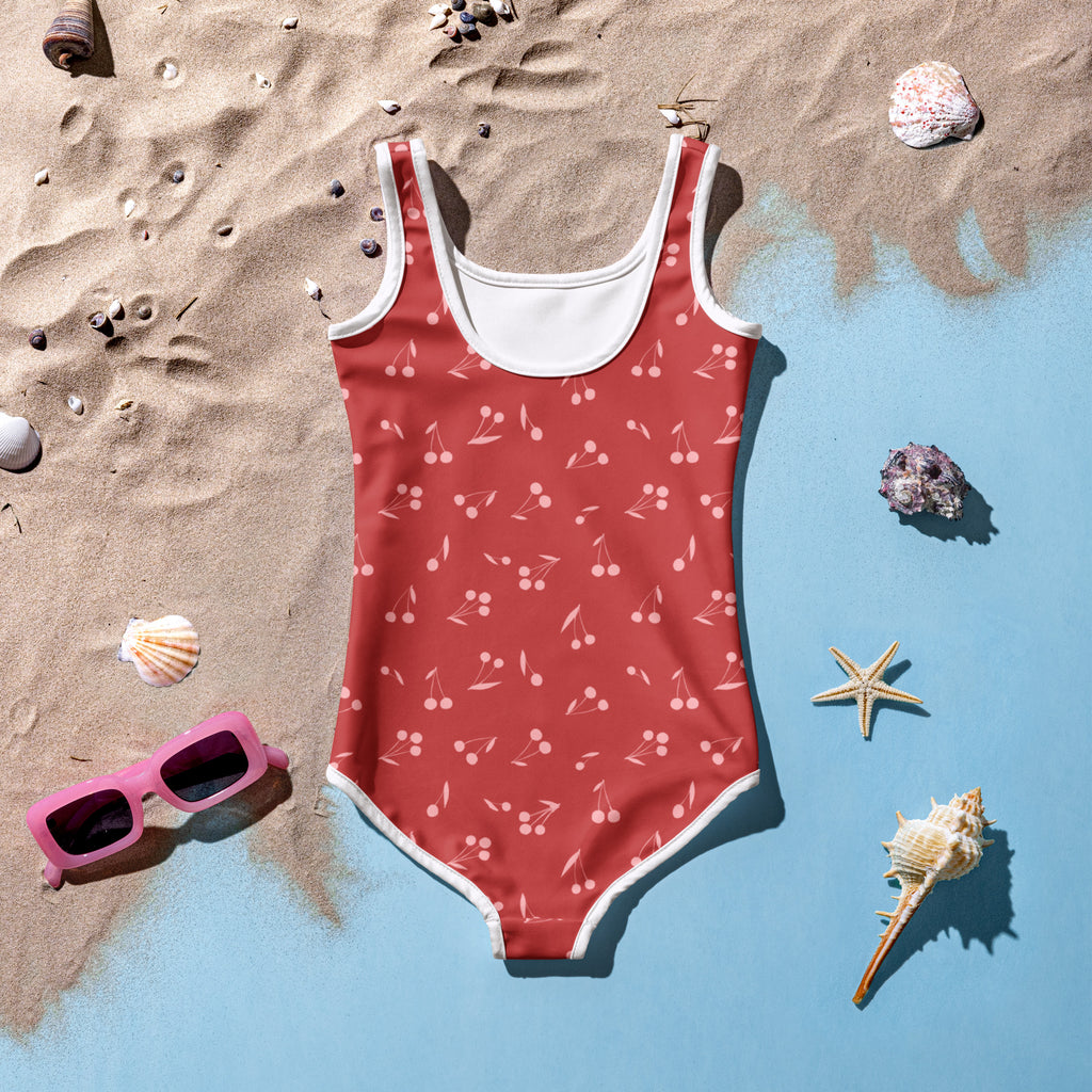 Girls red one-piece swimsuit with white trim and cherry pattern made of buttery soft fabric with UPF 50 plus protection