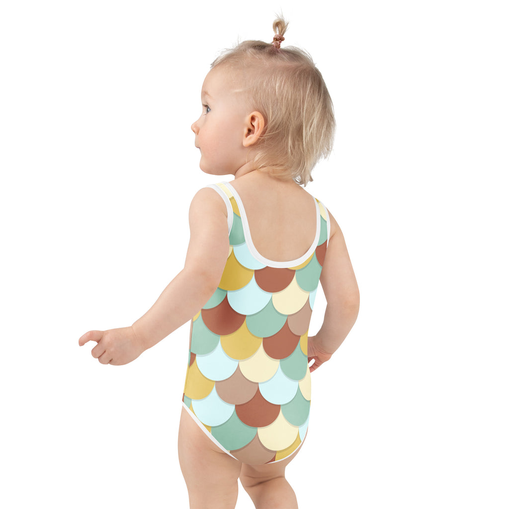 A toddler wearing a girls retro mermaid scales buttery soft swimsuit with upf 50 plus in pastel mint green beige and terracotta