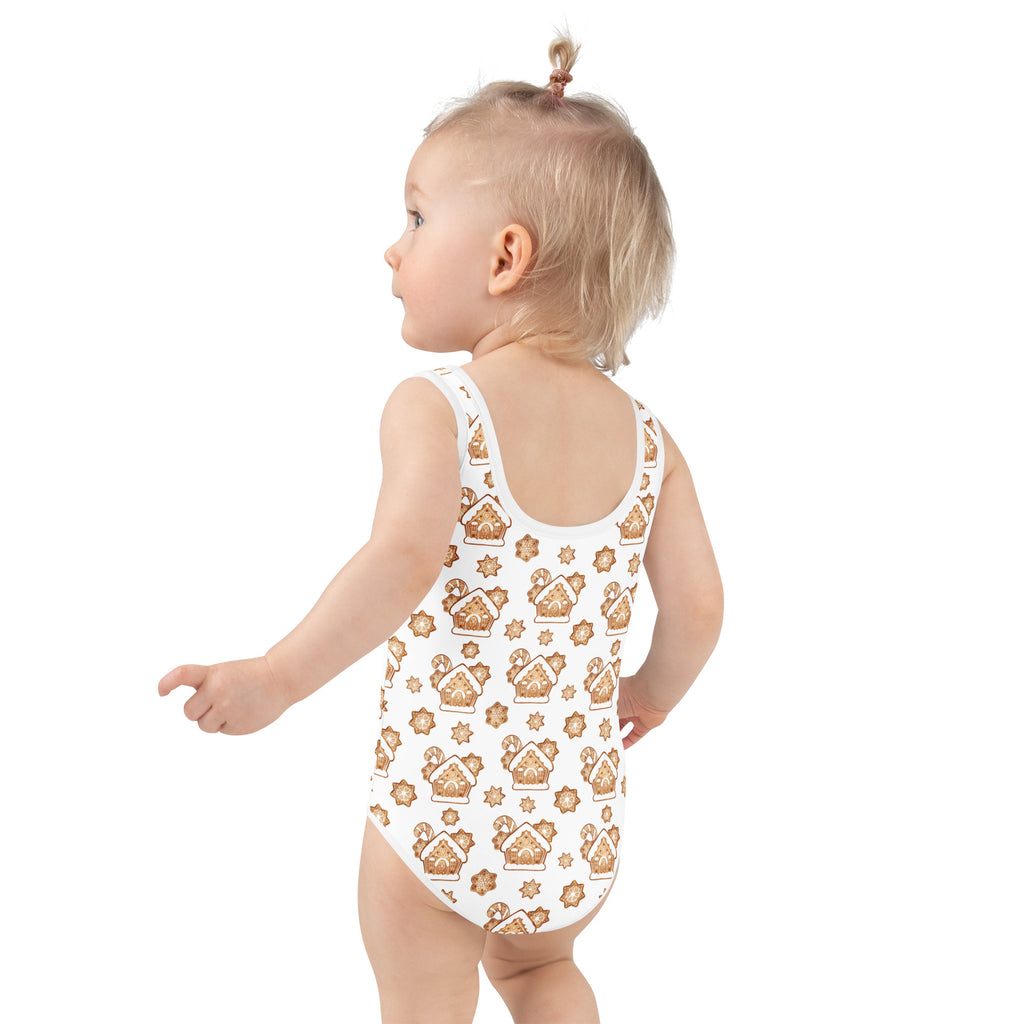 White girls one-piece swimsuit with buttery soft fabric and golden gingerbread house pattern and upf 50+ protection
