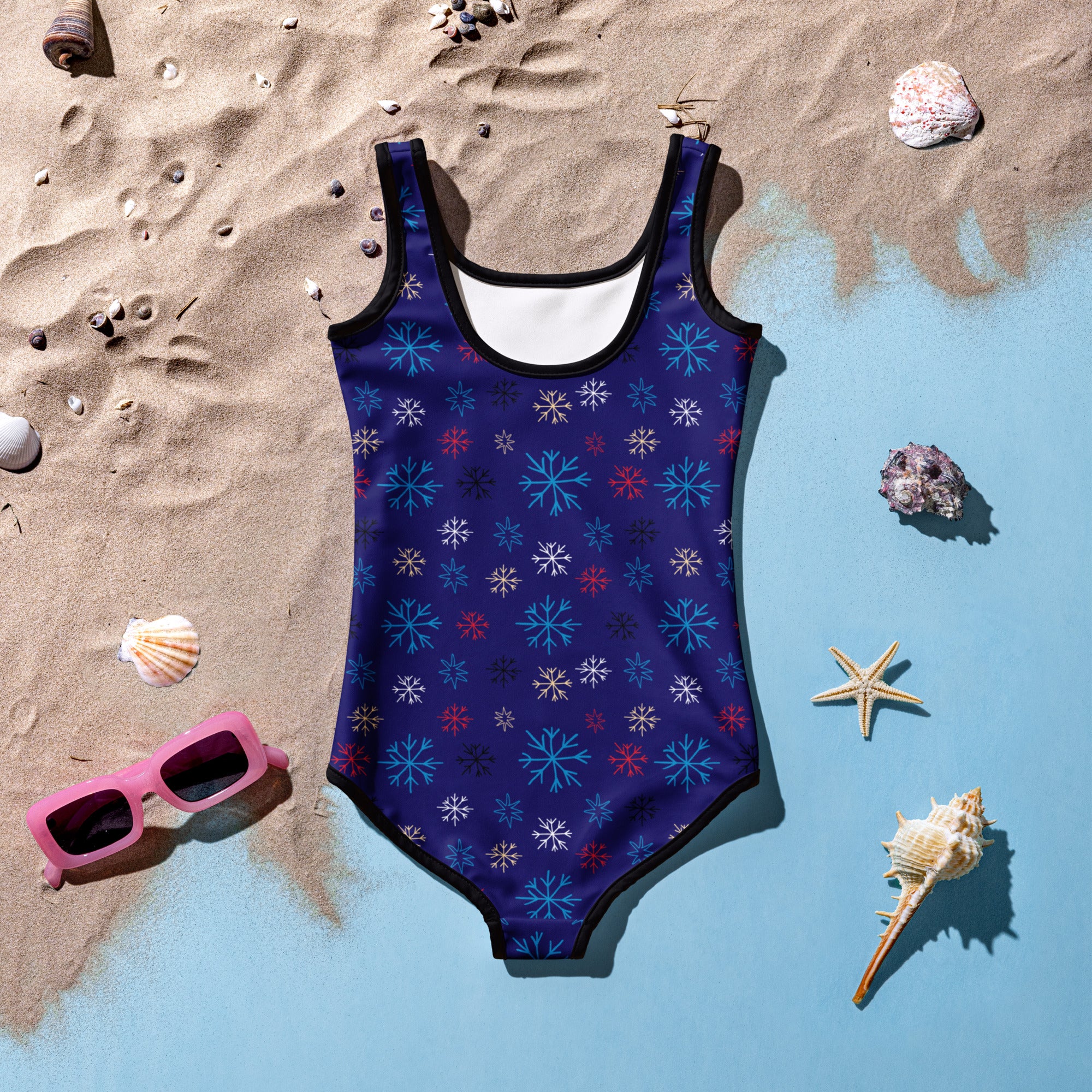 A navy blue girls one-piece winter snowflake swimsuit with buttery soft fabric, playful pattern, and UPF 50 plus protection