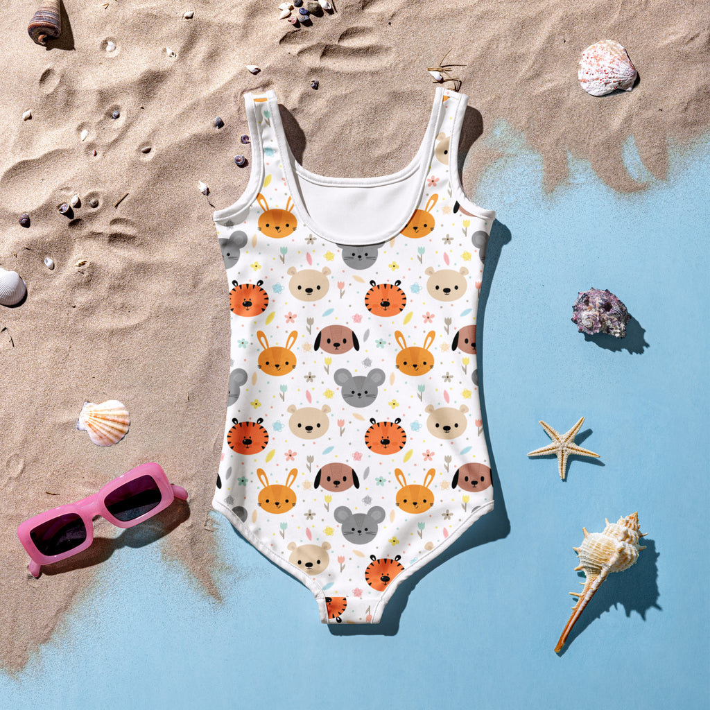 A white girls one-piece swimsuit with buttery soft fabric, cartoon animal faces pattern, and UPF 50+ sun protection