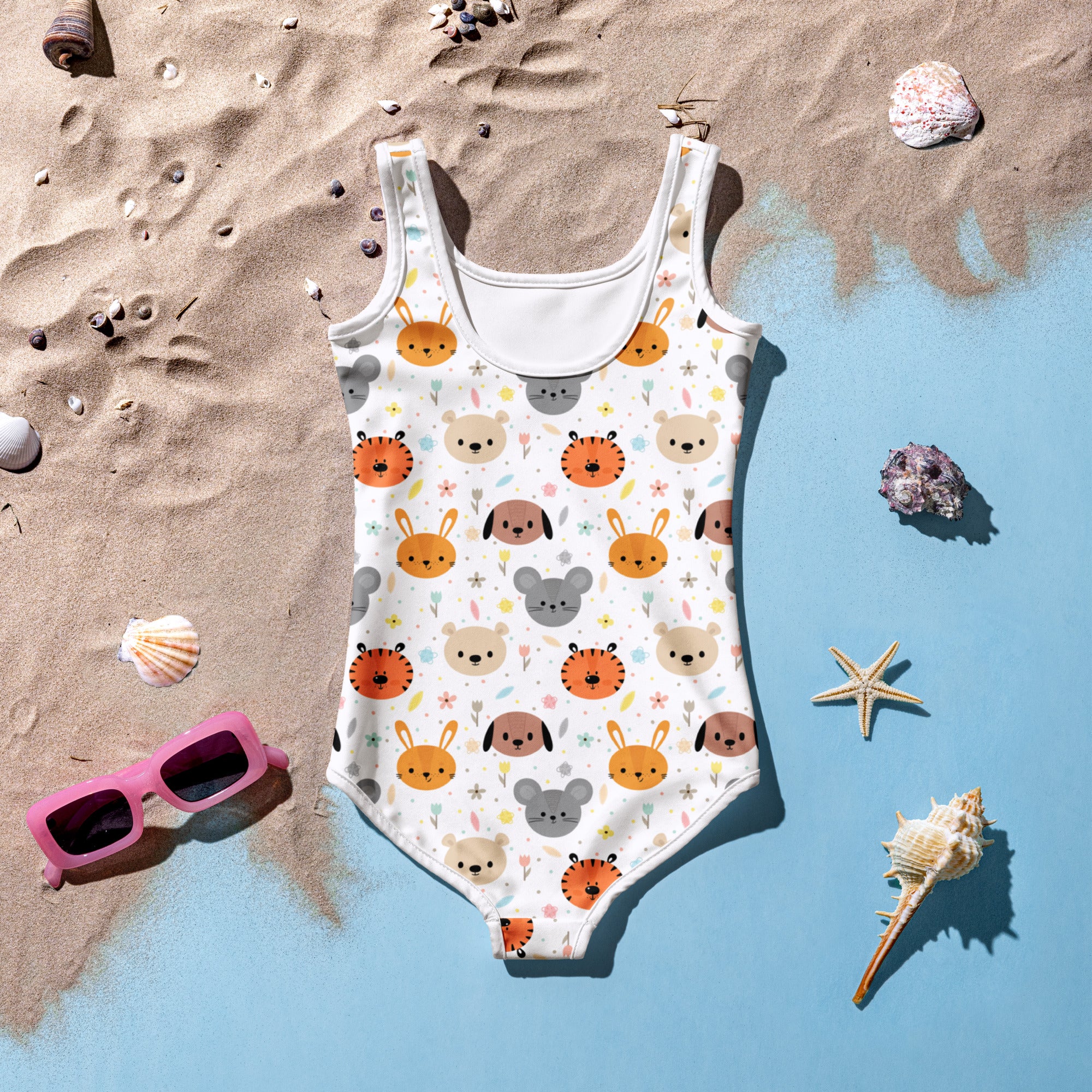 A white girls one-piece swimsuit with buttery soft fabric, cartoon animal faces pattern, and UPF 50+ sun protection