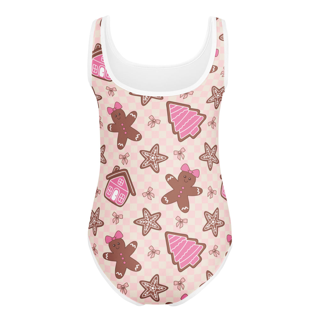 Girls pink gingerbread buttery soft one-piece swimsuit with white trim and festive cookie pattern for dance and gymnastics
