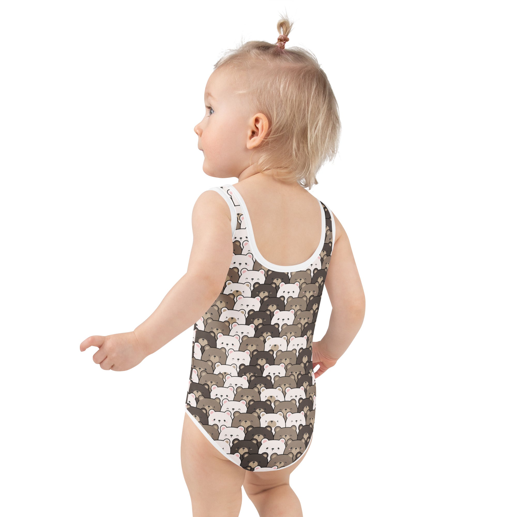 A toddler wearing a girls bear face buttery soft swimsuit with UPF 50 plus in dark brown with white bear pattern