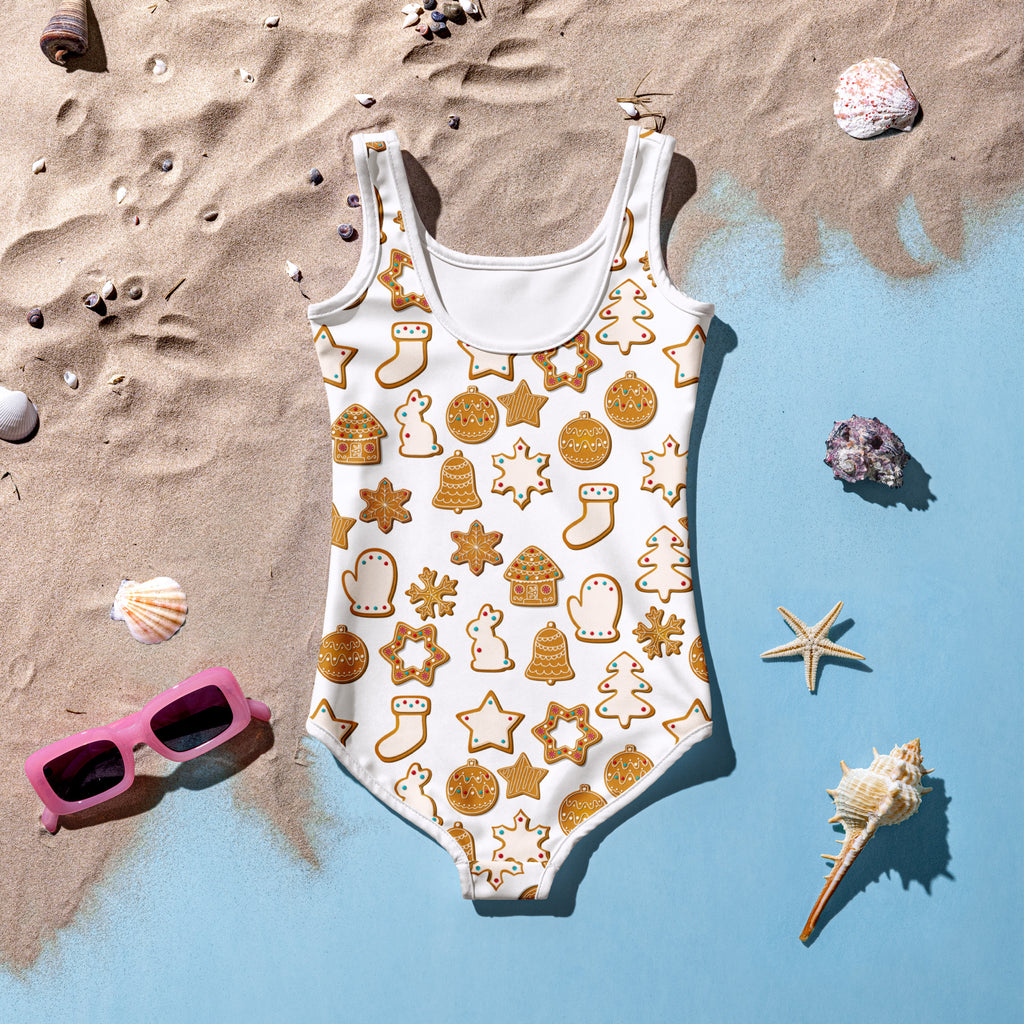 Girls white one-piece swimsuit with buttery soft fabric festive golden gingerbread cookies pattern and UPF 50 plus protection