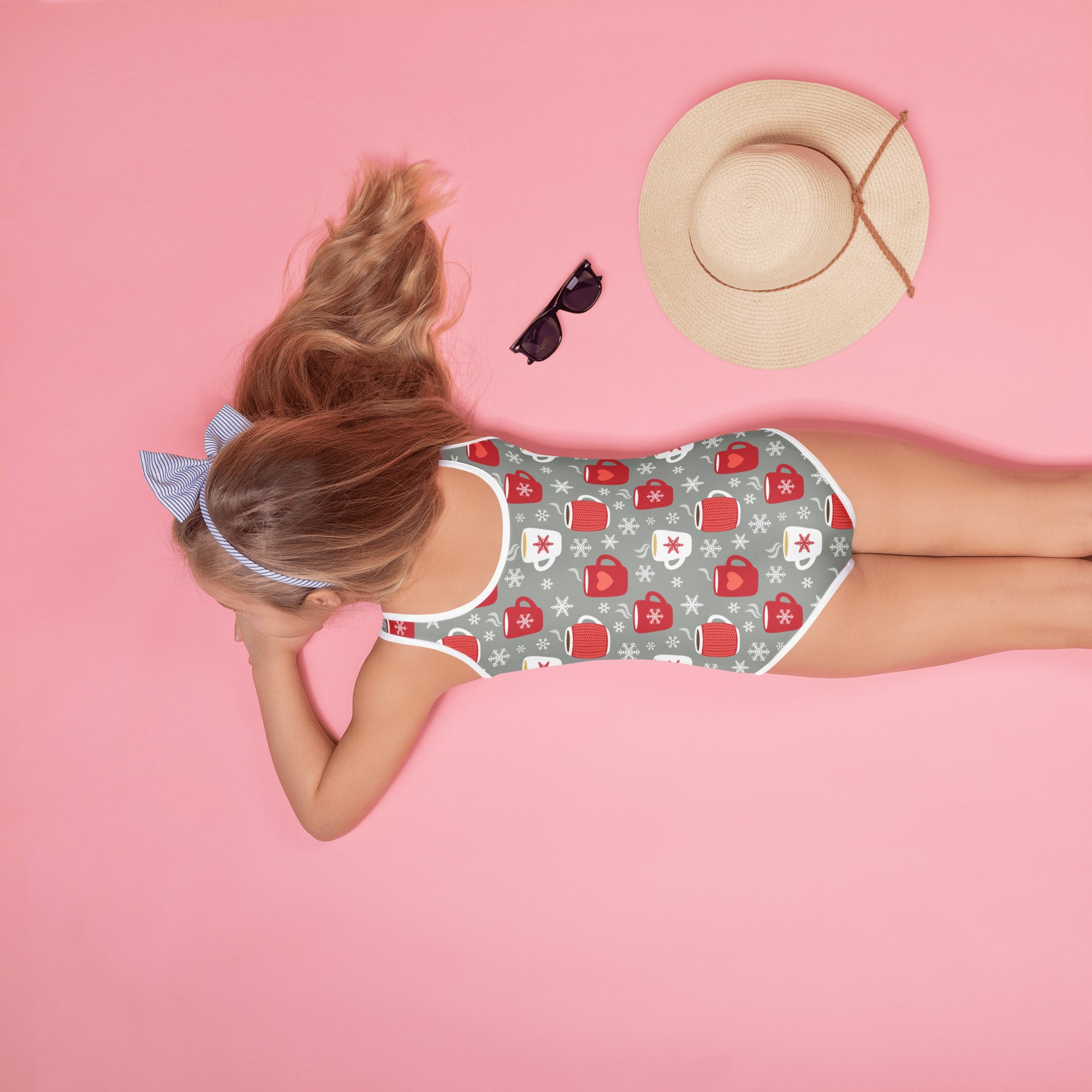 A gray girls one-piece swimsuit with red and white cozy cocoa mug and snowflake pattern and UPF 50+ protection