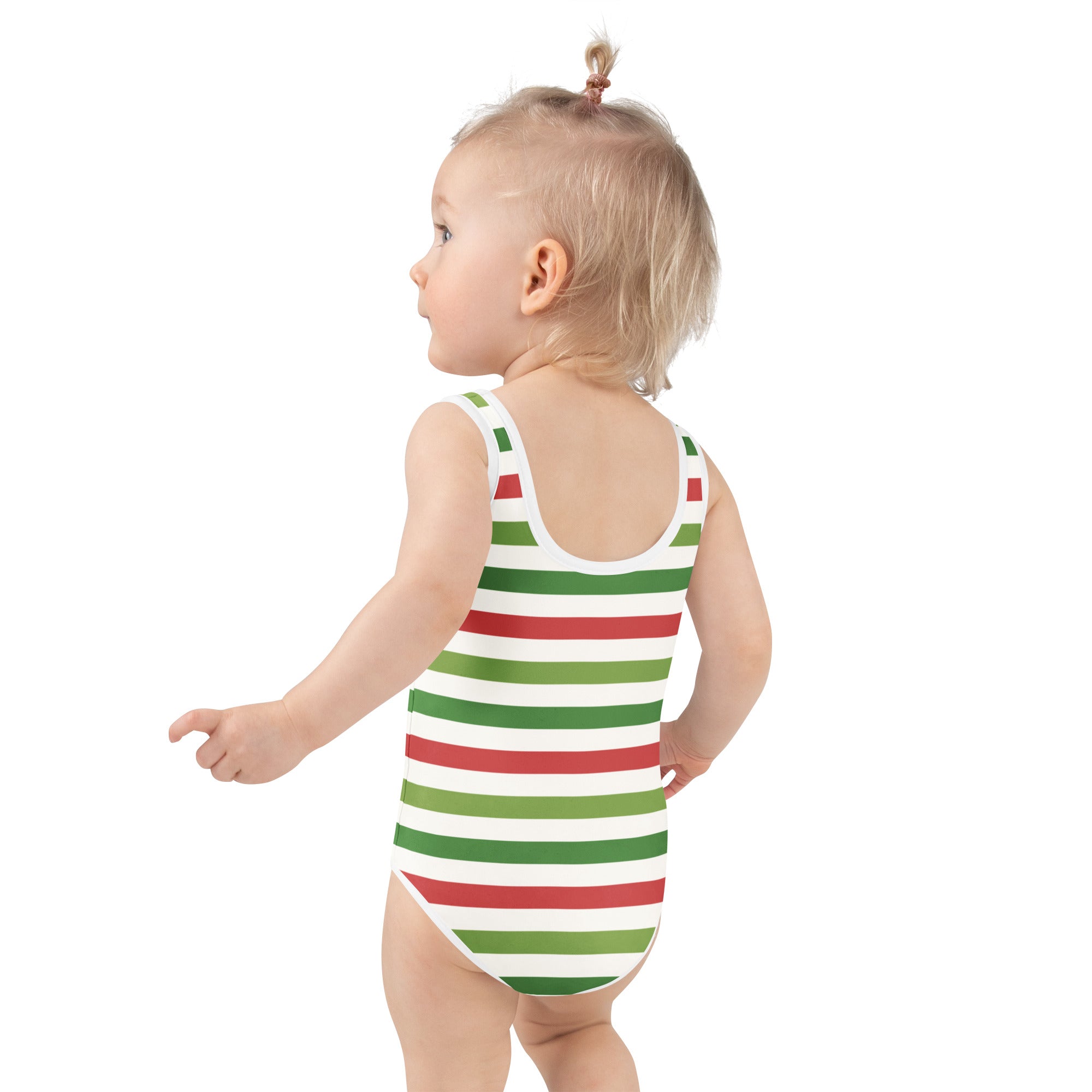 A toddler wearing a girls striped Christmas buttery soft swimsuit in red green and white with UPF 50 plus protection