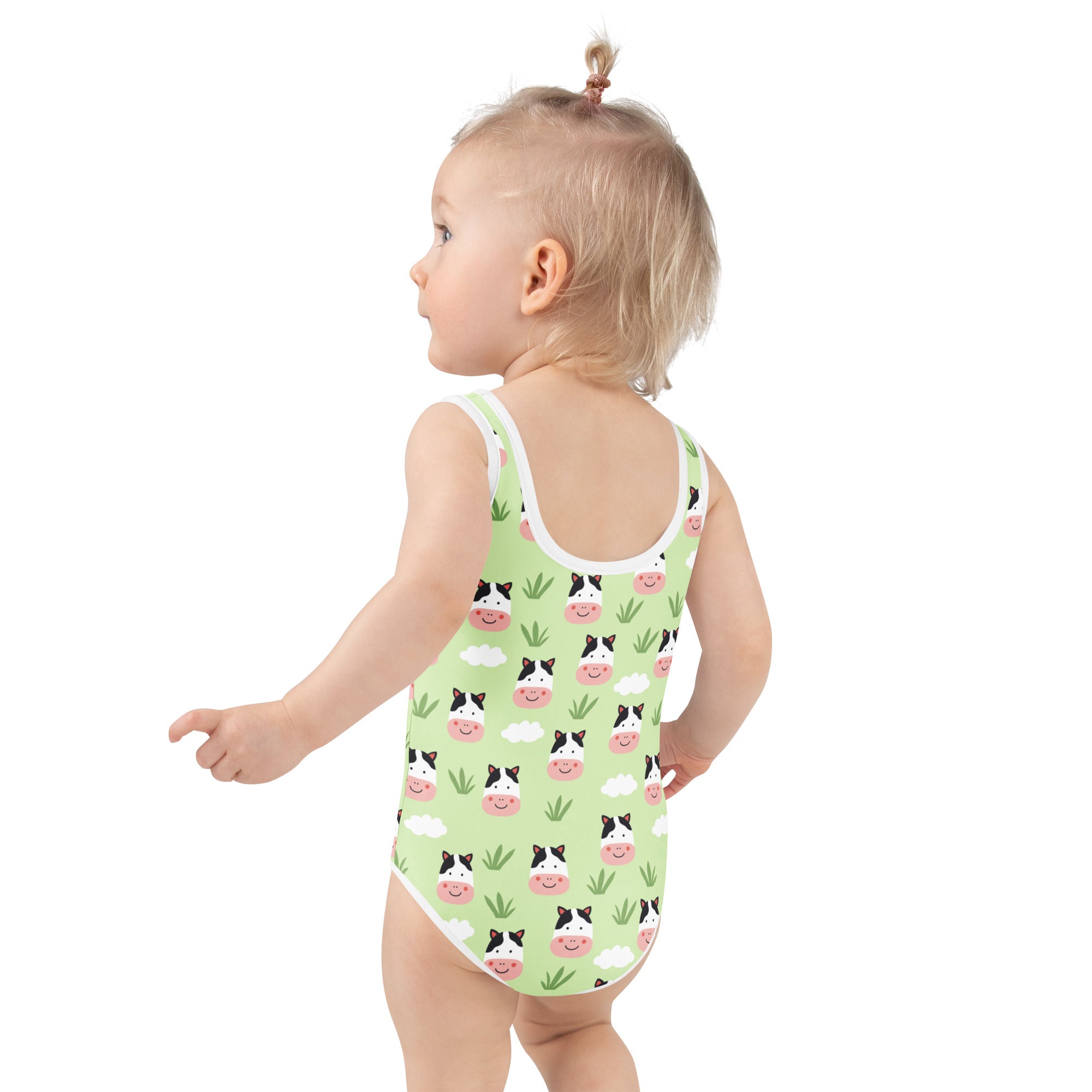 Girls green cow print buttery soft one-piece swimsuit with white trim and UPF 50+ sun protection