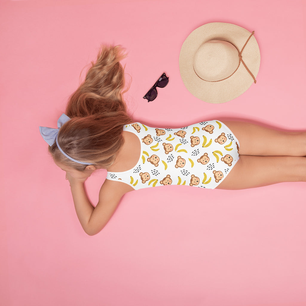 White girls one-piece swimsuit with playful brown monkeys and yellow bananas pattern, buttery soft with UPF 50+ protection