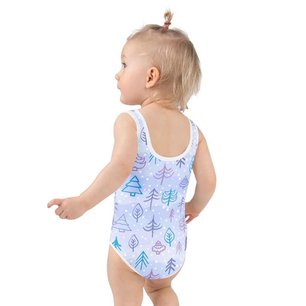 A light blue girls winter forest buttery soft one-piece swimsuit with upf 50 plus featuring teal purple tree patterns