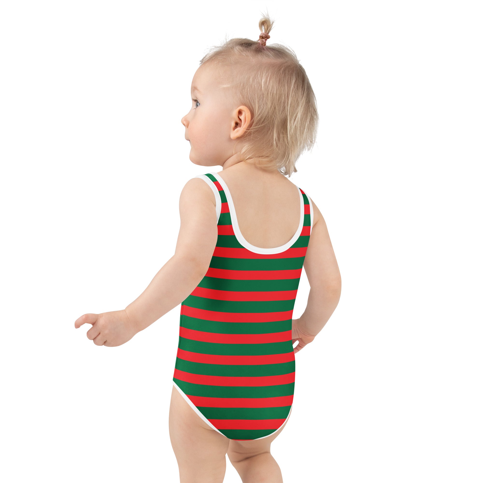 A toddler wearing a girls festive christmas stripes buttery soft red and green striped swimsuit with UPF 50+