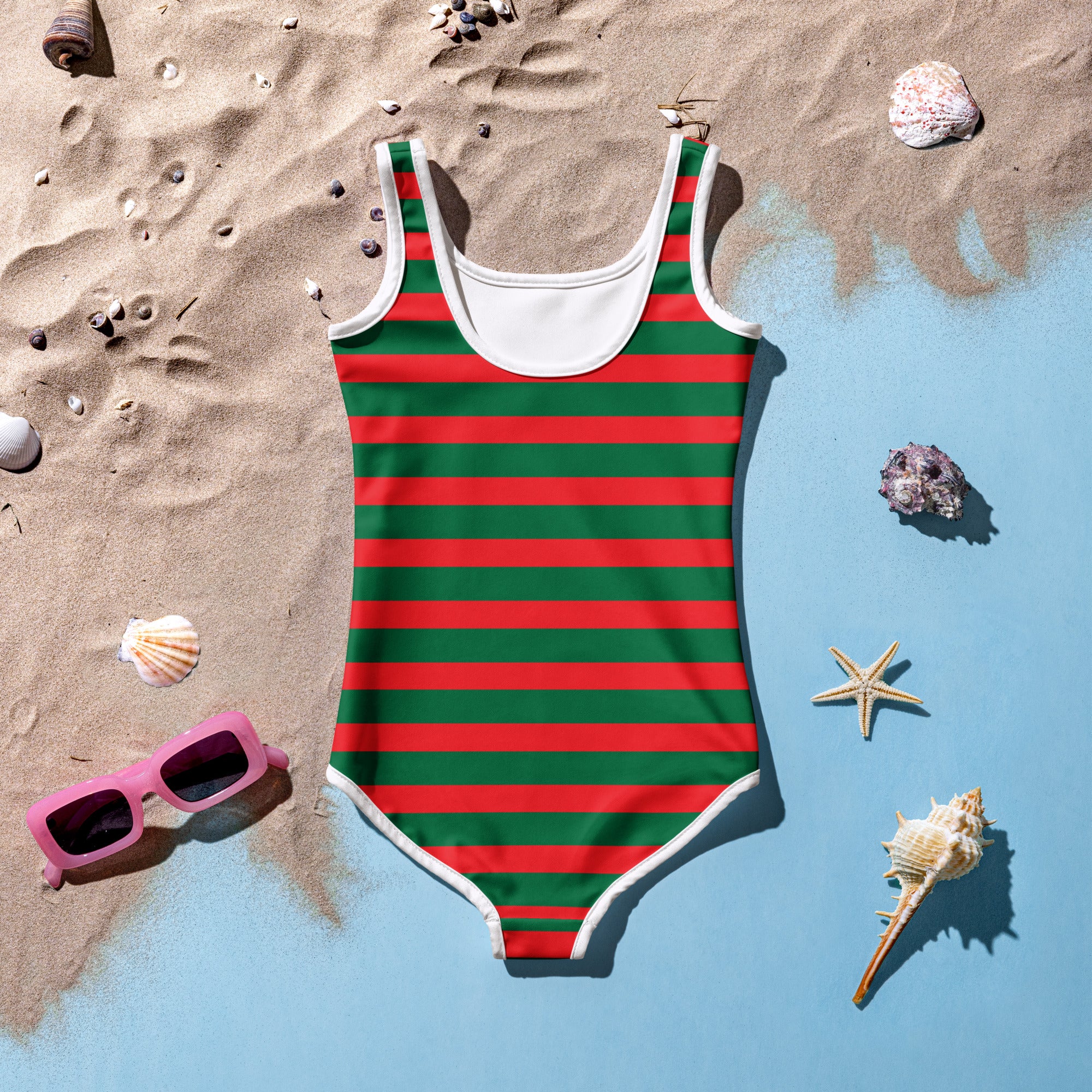 A vibrant red and green striped girls festive christmas swimsuit with white trim and buttery soft fabric with UPF 50+ protection