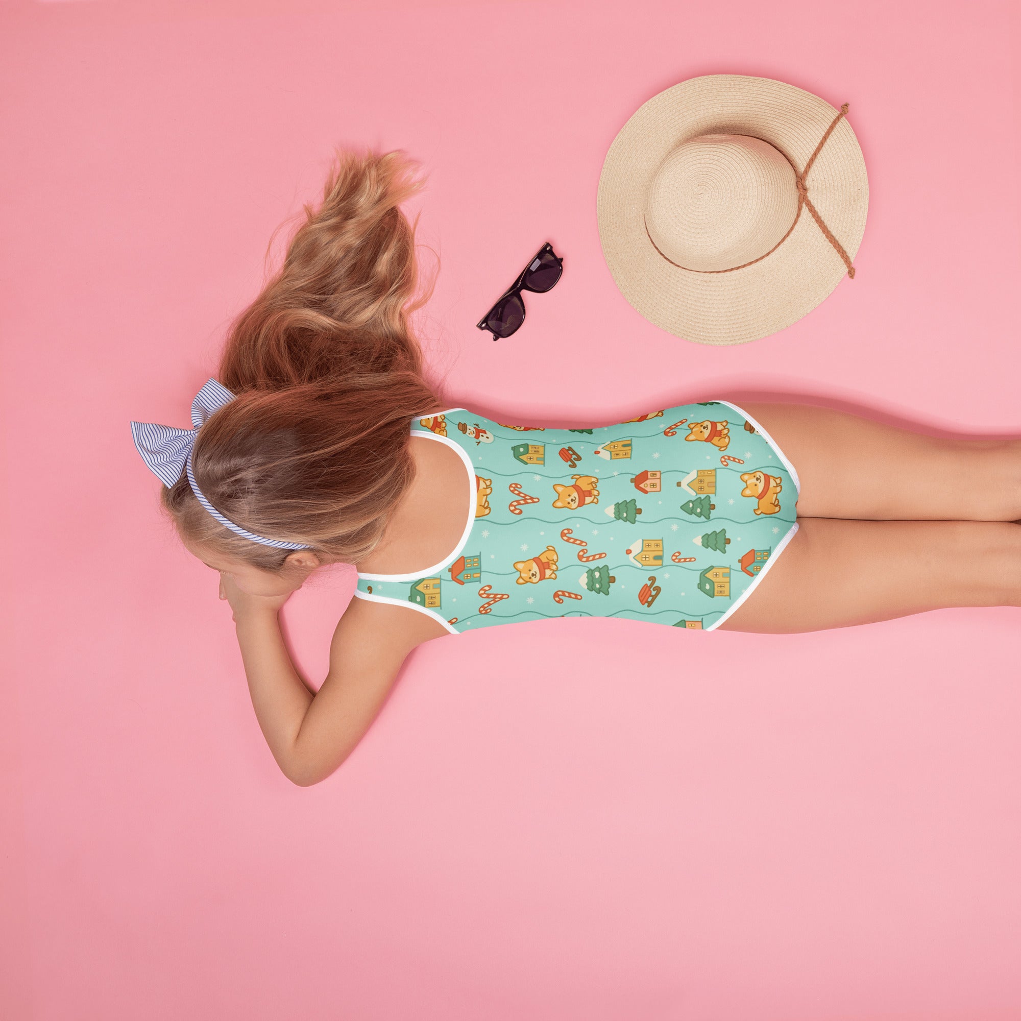 A mint green girls one-piece swimsuit with cartoon bears houses candy canes buttery soft fabric and UPF 50 plus protection