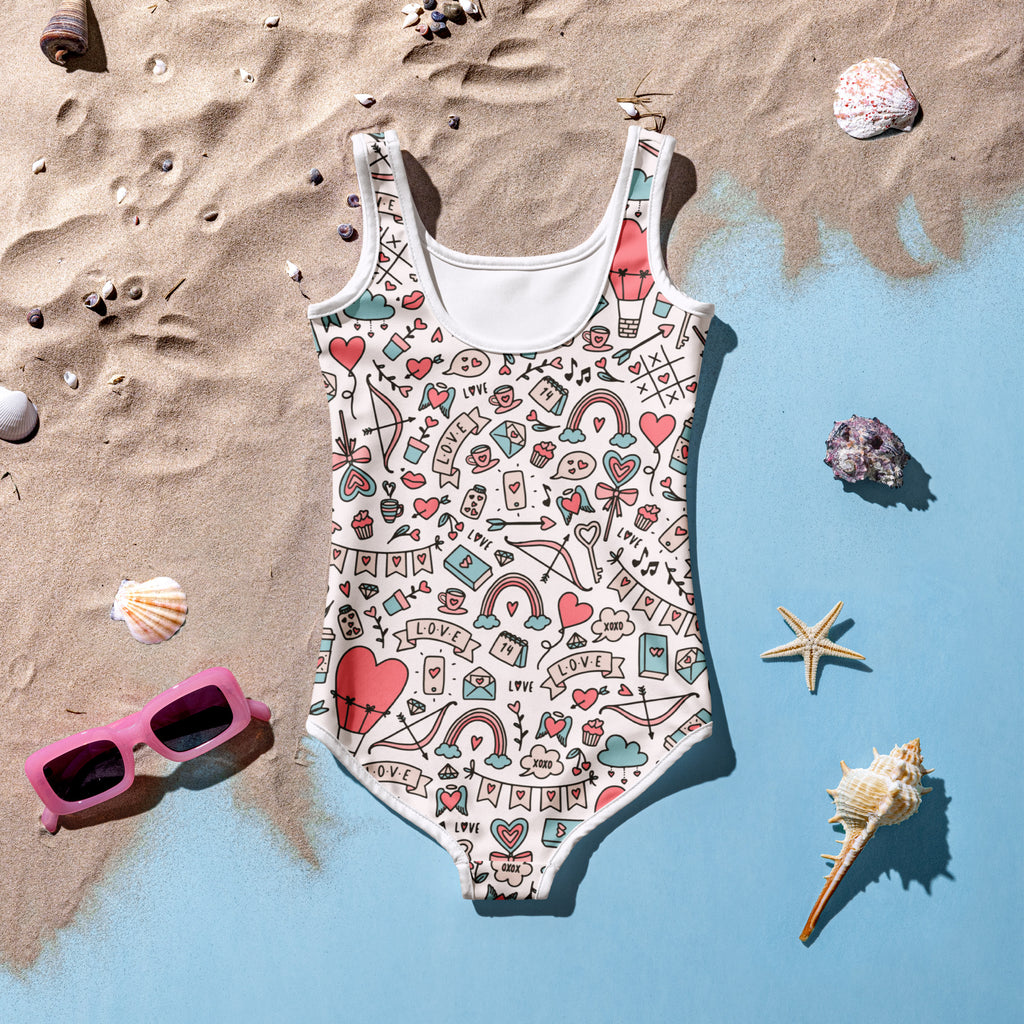 Girls Valentine’s Day doodle heart buttery soft off-white swimsuit with hearts rainbows bows love banners and UPF 50+ protection