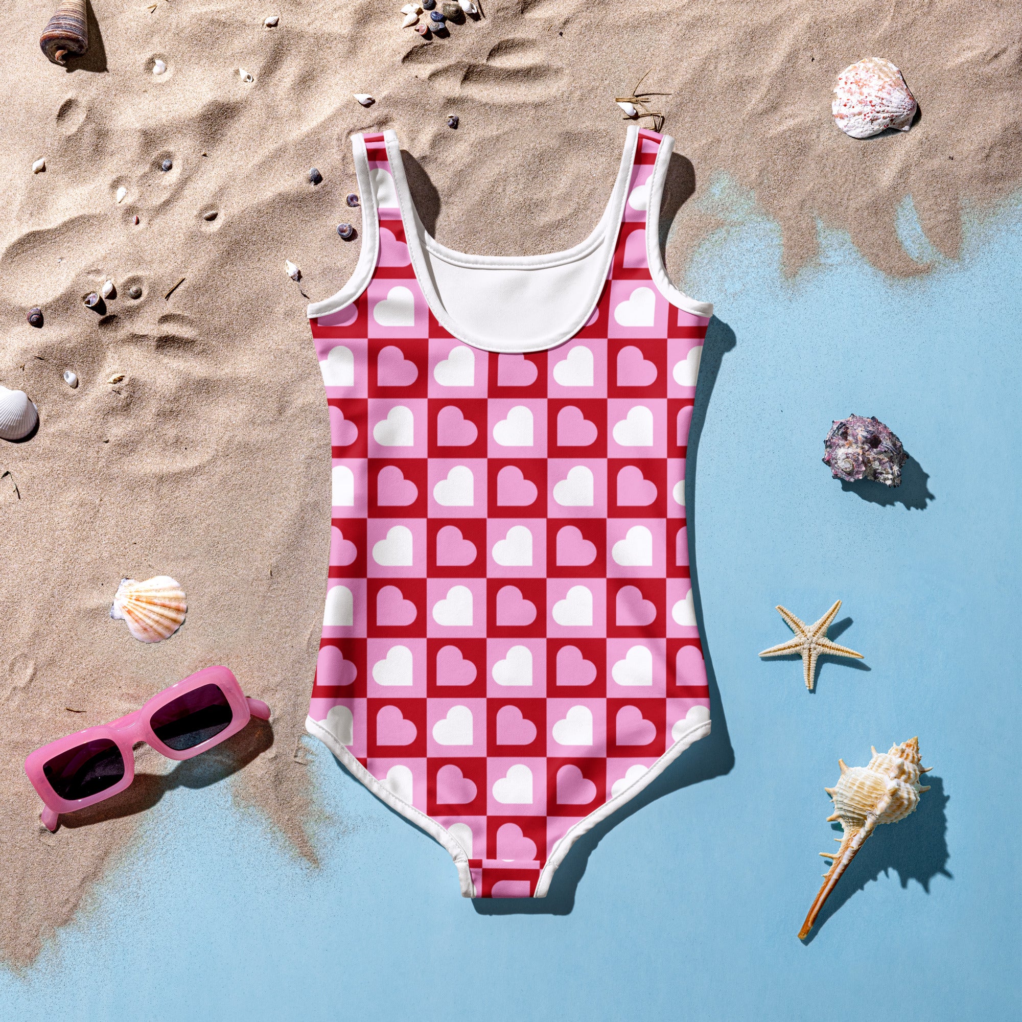 Girls pink and white heart patterned one-piece swimsuit with checkered design buttery soft fabric upf 50 plus protection