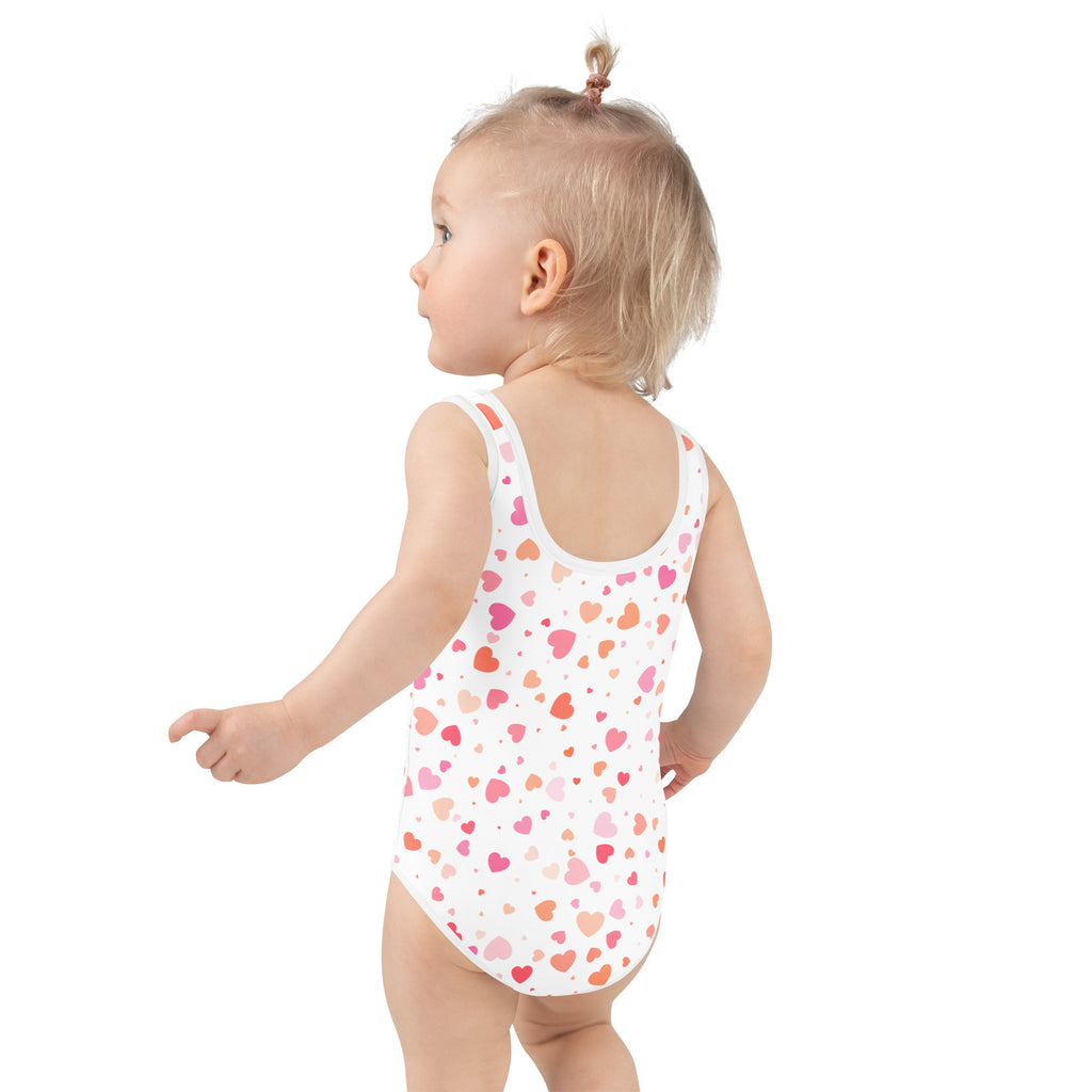 A white girls one-piece swimsuit with pink and orange hearts buttery soft fabric and UPF 50 plus protection