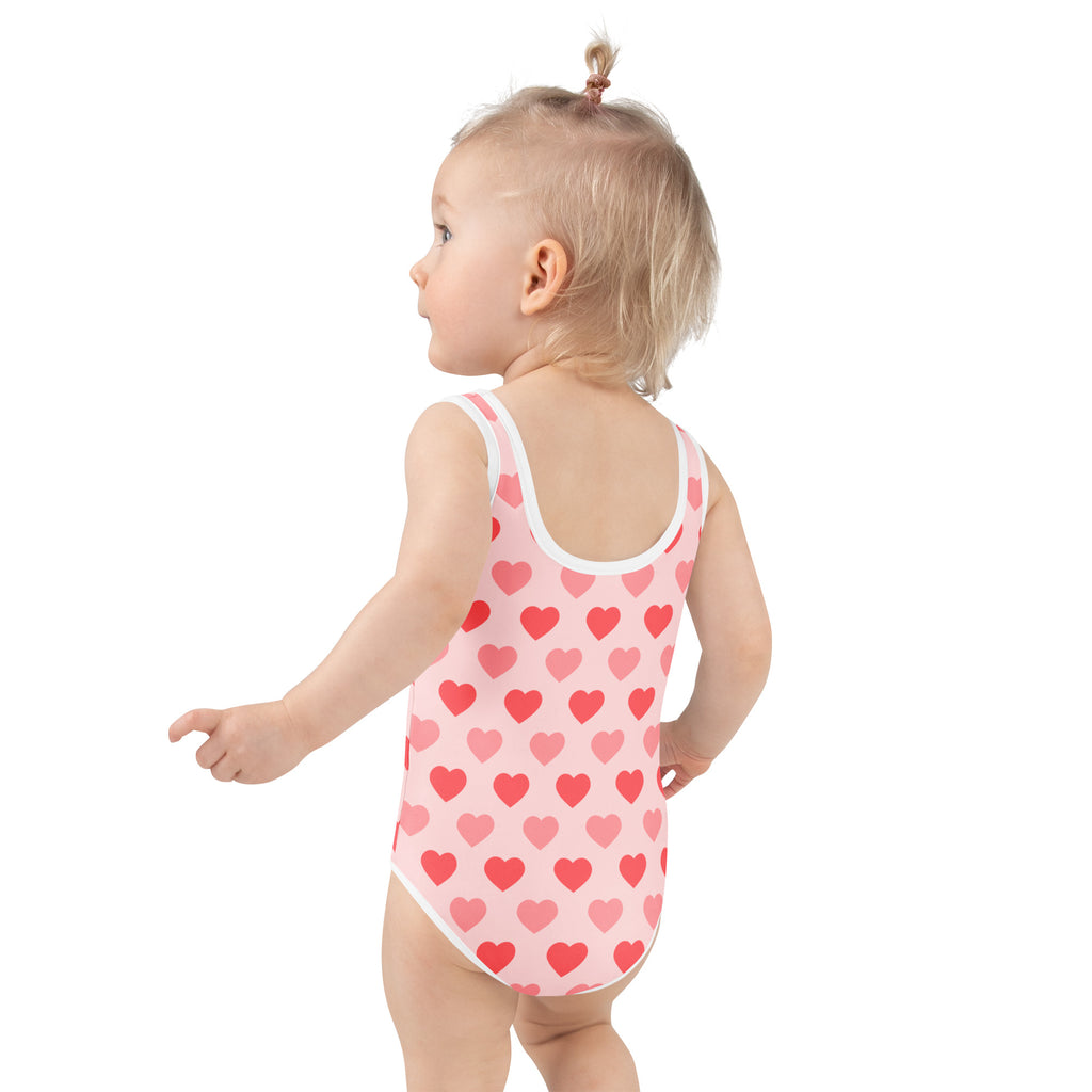 Girls pink heart buttery soft one-piece swimsuit with white trim and UPF 50 plus double layered front protection