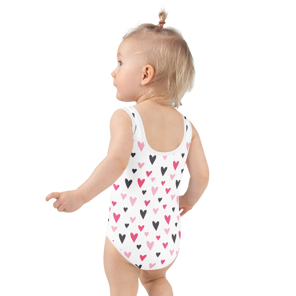 White one-piece girls Valentine’s Day swimsuit with pink and black hearts buttery soft fabric UPF 50 plus protection