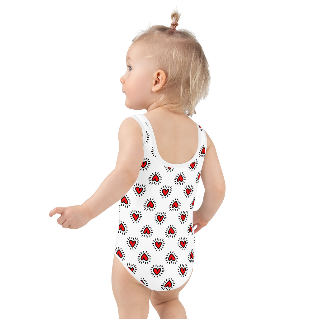 Girls Valentine’s Day doodle heart buttery soft white swimsuit with red hearts outlined in black and radiating dots upf 50+