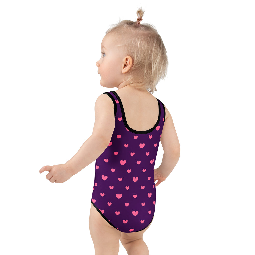Girls purple valentine’s day buttery soft one-piece swimsuit with pink heart pattern black trim and upf 50+ protection