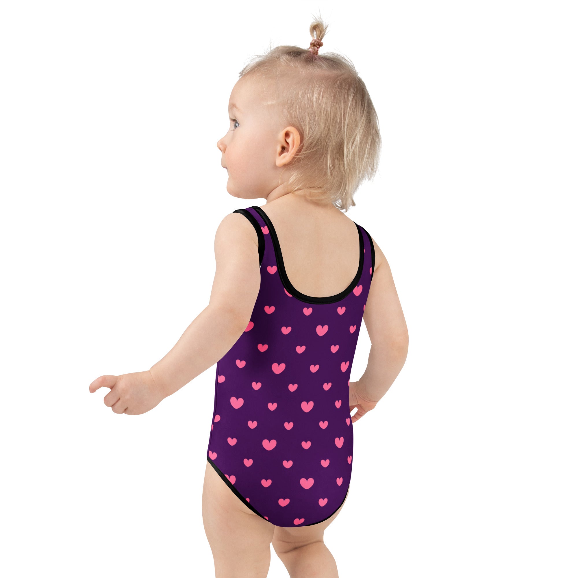 Girls purple valentine’s day buttery soft one-piece swimsuit with pink heart pattern black trim and upf 50+ protection