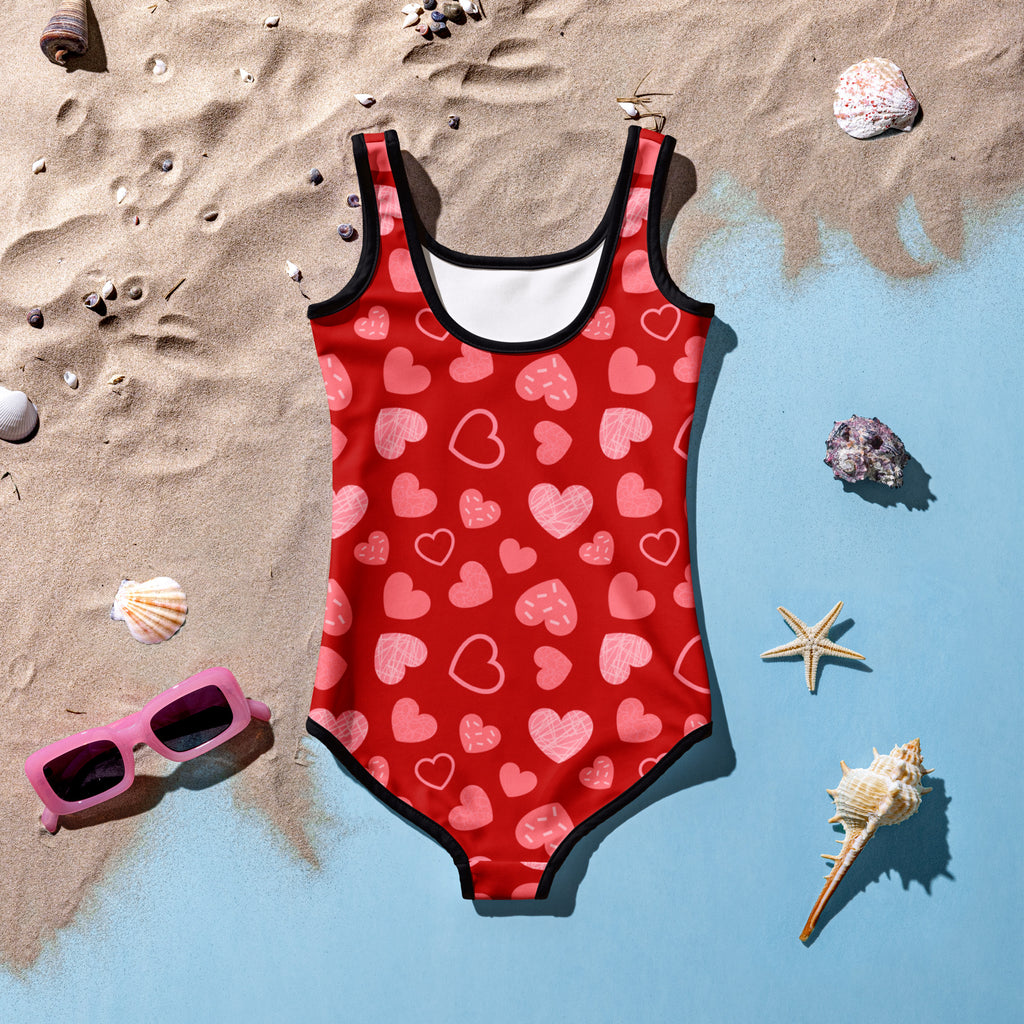 Girls red heart pattern buttery soft swimsuit with upf 50 plus and black trim on neckline and leg openings