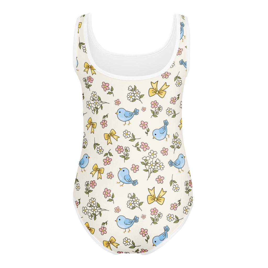 A charming off-white buttery soft girls one-piece swimsuit with blue birds yellow bows and floral print for dance and gymnastics
