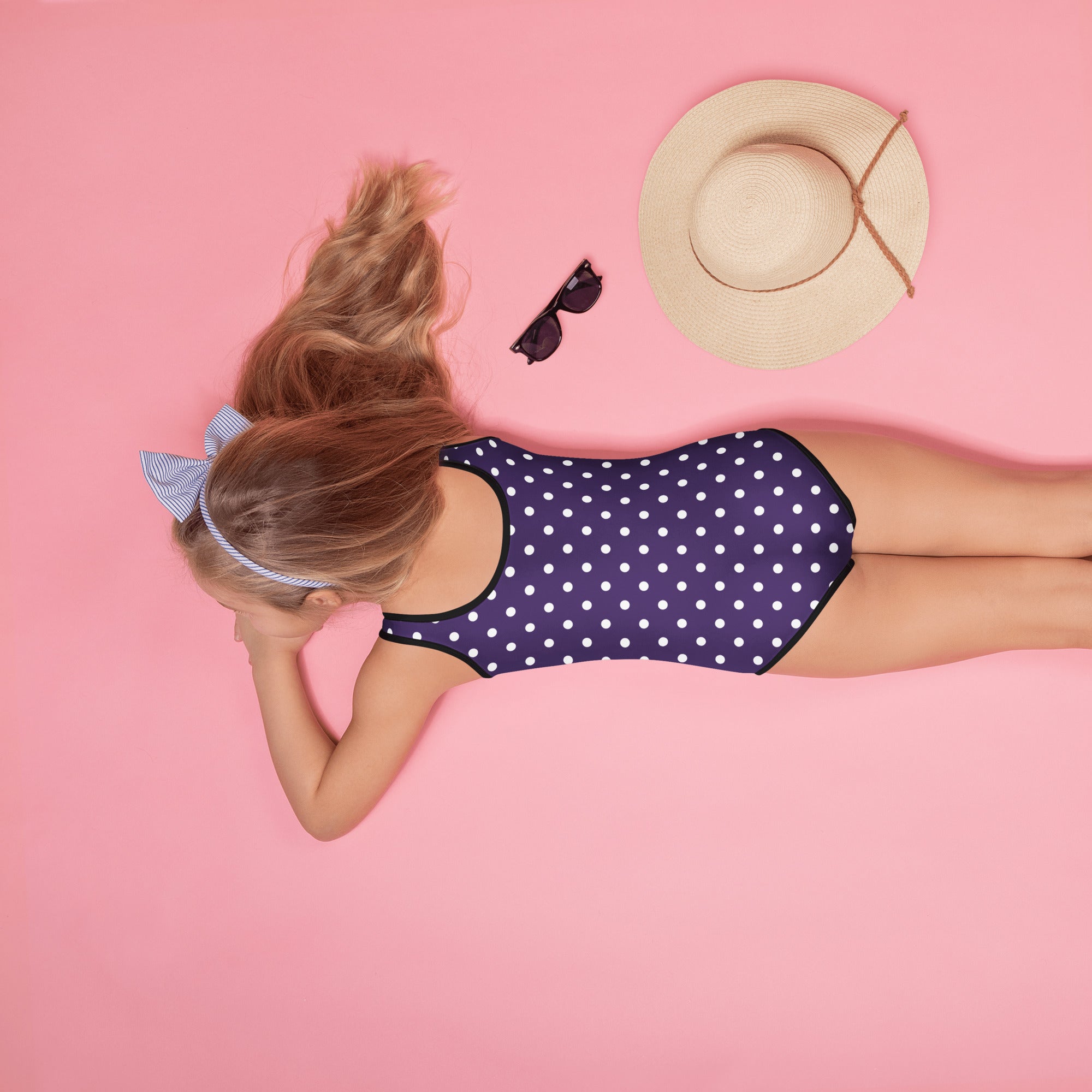 Girls dark purple buttery soft one-piece swimsuit with white polka dots black trim and upf 50 plus protection