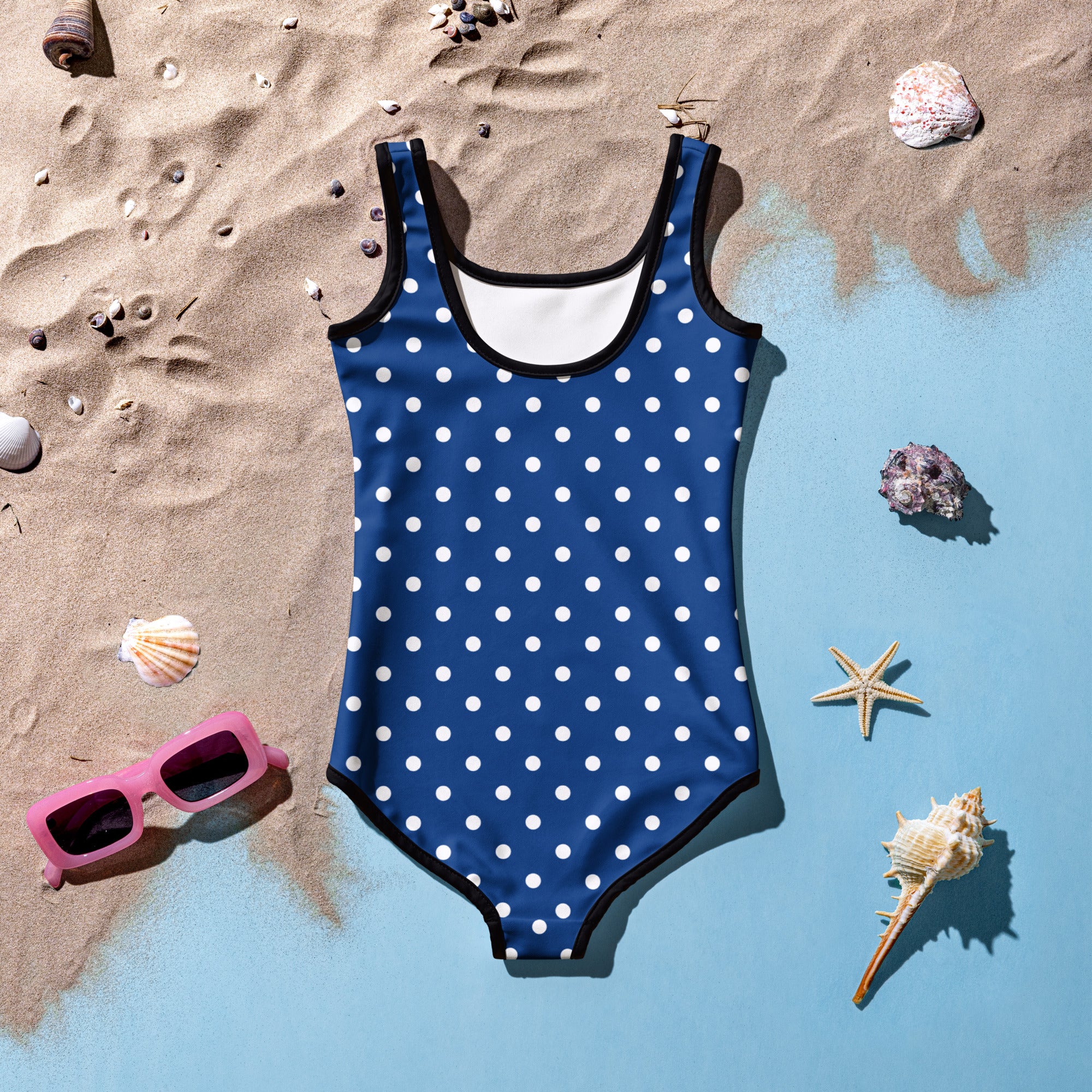 Girls dark blue polka dot buttery soft one-piece swimsuit with black trim and UPF 50 plus protection front view