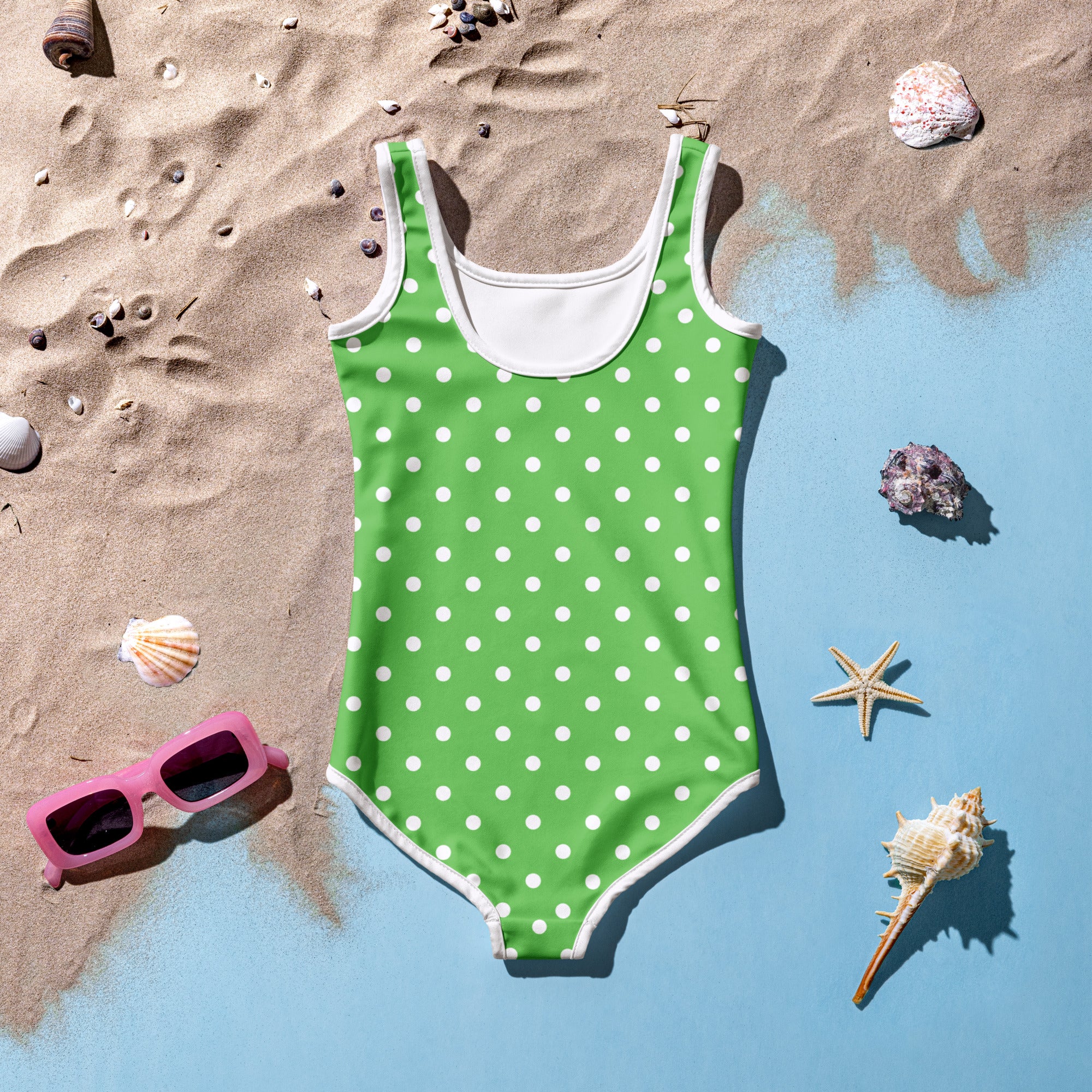 Girls green one-piece swimsuit with white polka dots and trim made from buttery soft fabric with UPF 50+ protection