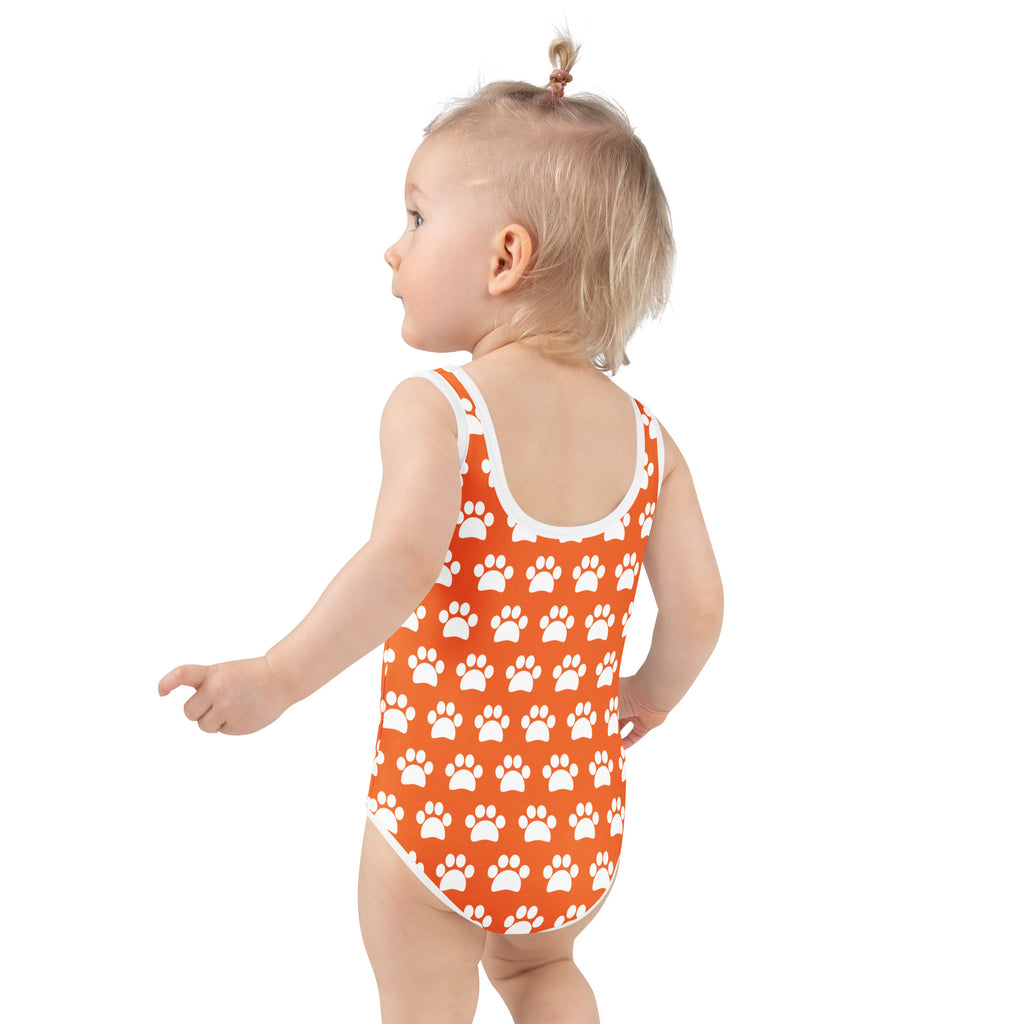 Girls orange one-piece swimsuit with white paw print pattern and trim made from buttery soft fabric with UPF 50+ protection