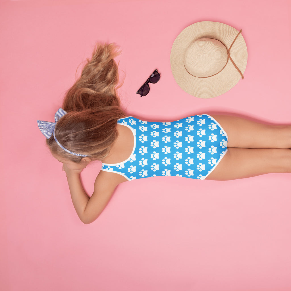 Girls sky blue one-piece swimsuit with white paw print pattern white trim buttery soft fabric and UPF 50+ protection
