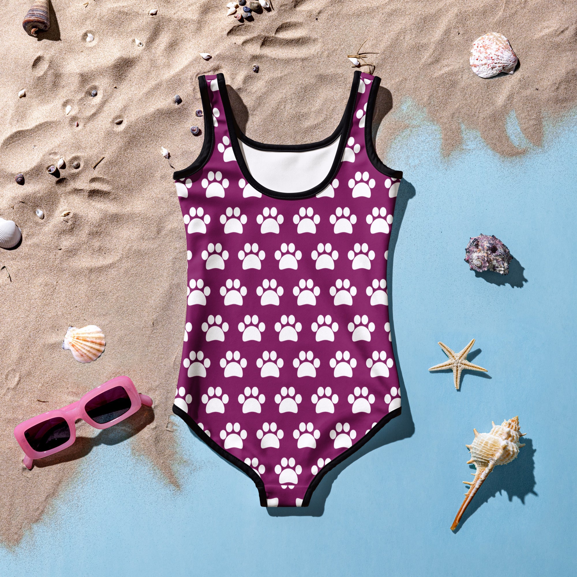 Girls purple paw print buttery soft swimsuit with black trim and upf 50 plus protection double layered front