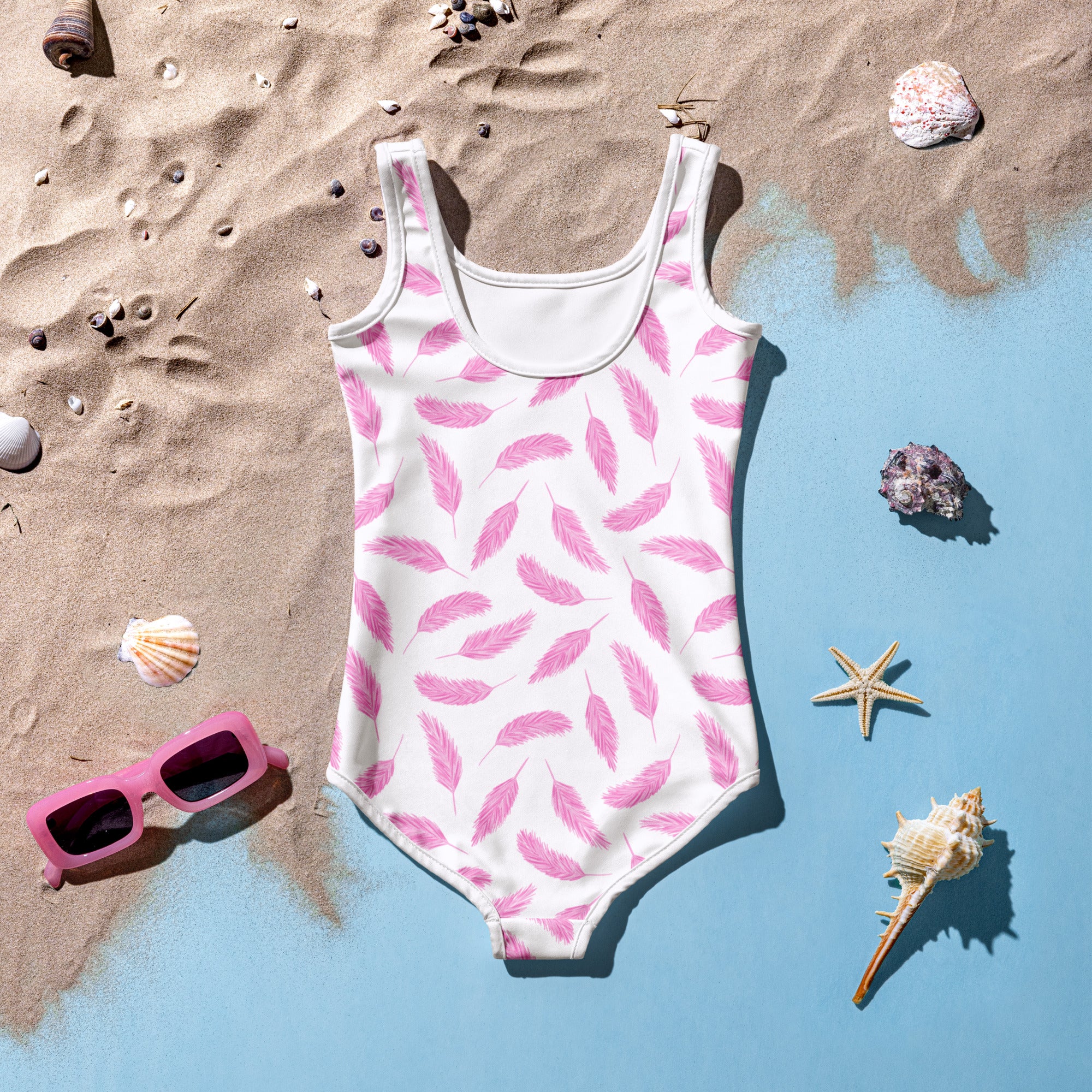 White one-piece girls swimsuit with pink flamingo feather pattern buttery soft fabric and upf 50+ protection
