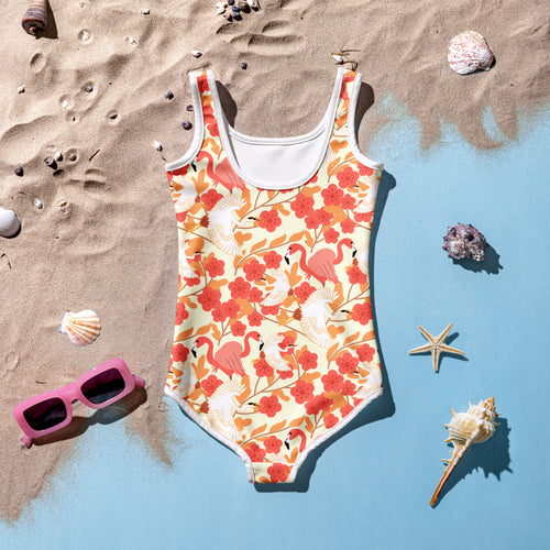 A vibrant coral and cream girls floral flamingo and pelican swimsuit with white trim and buttery soft fabric upf 50+