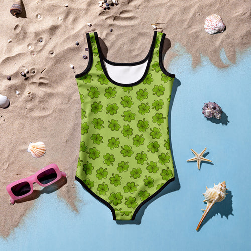 Girls clover buttery soft lime green swimsuit with black trim shamrock pattern and upf 50 plus double layered front