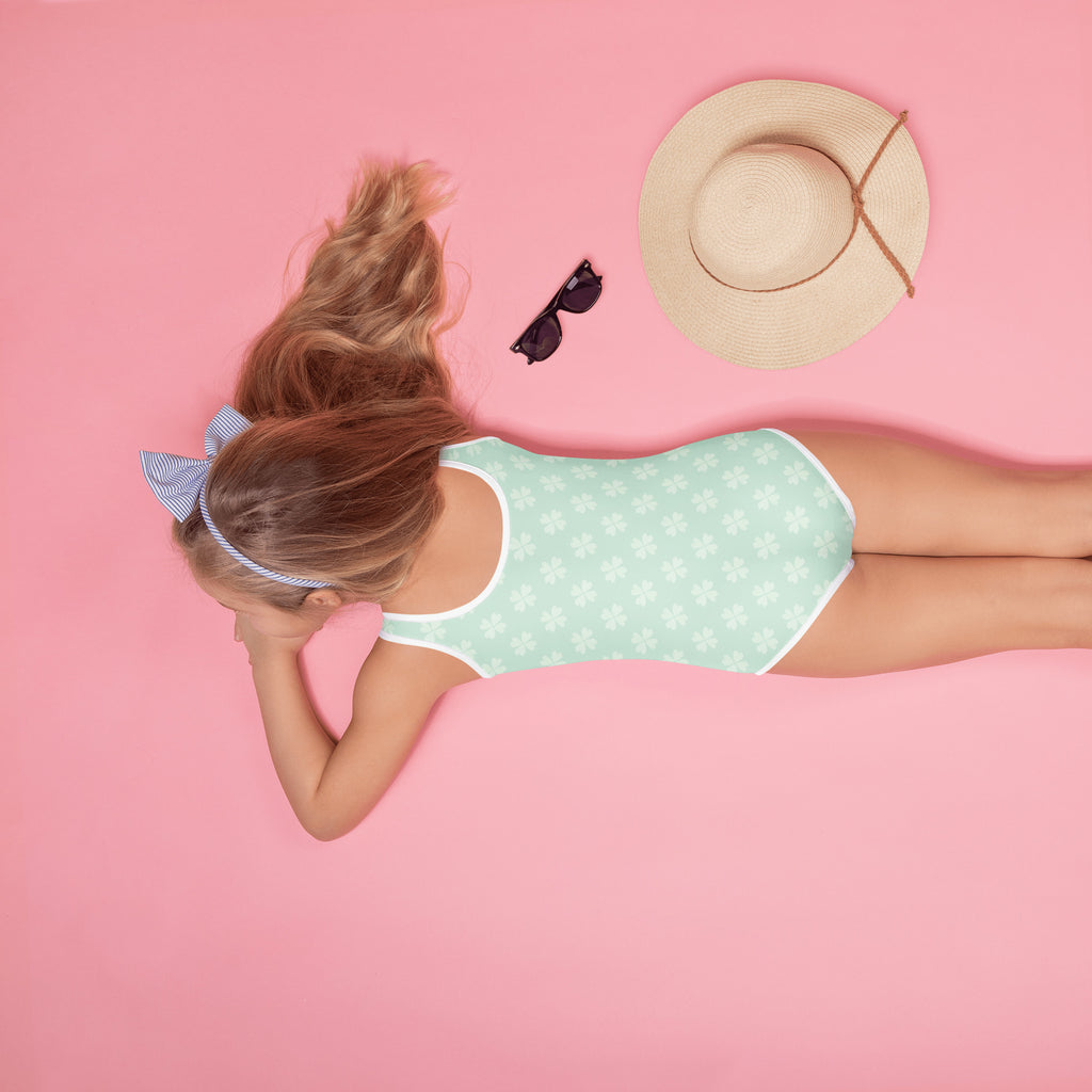 Girls mint shamrock buttery soft one-piece swimsuit with white trim and subtle polka dots UPF 50 plus protection
